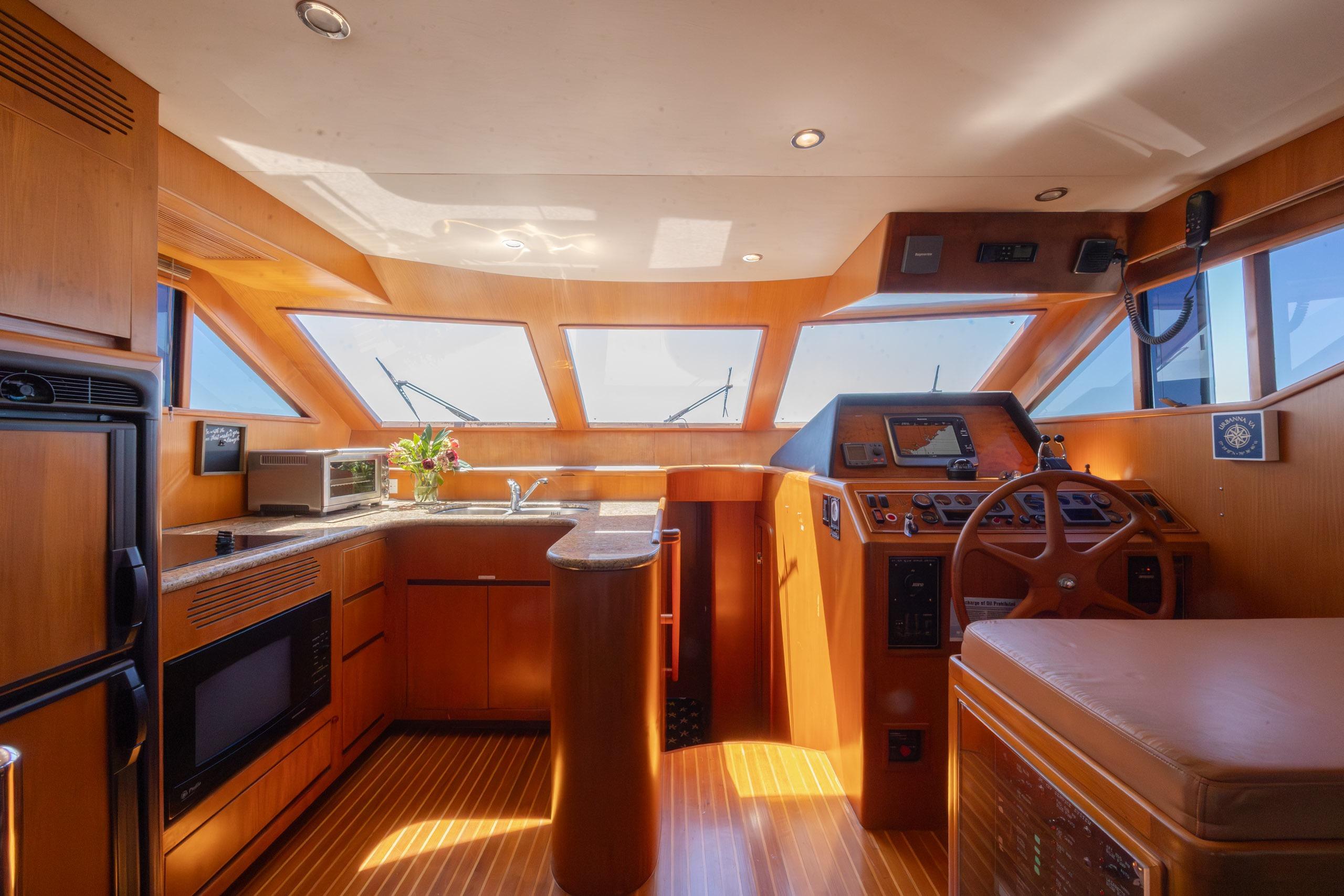 Luxurious interior of 2005 Ocean Alexander 52 Sedan yacht with modern helm and kitchen area.