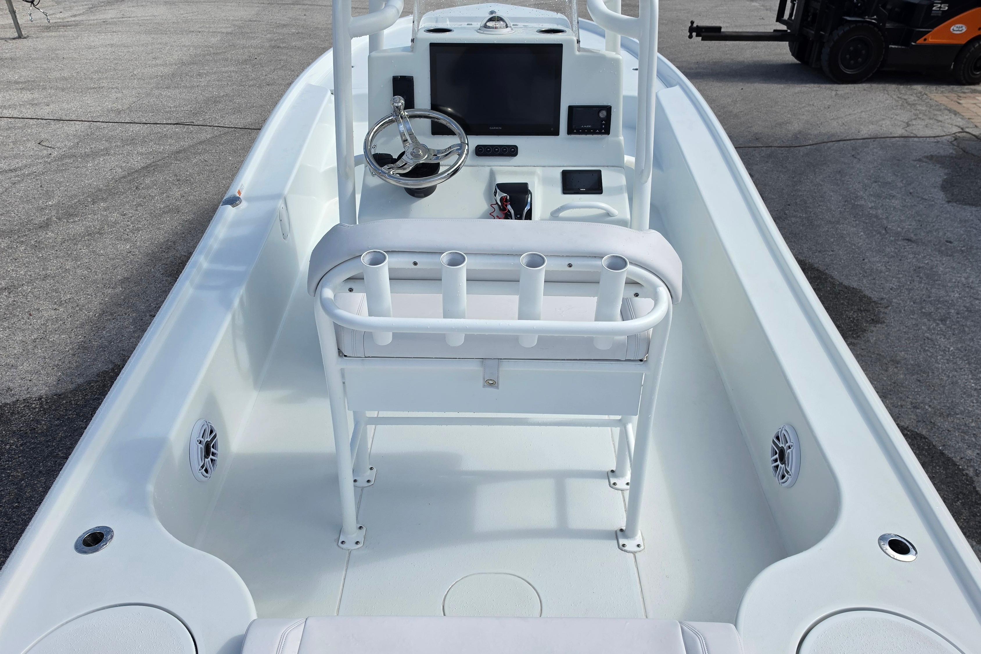 2026 Yellowfin 24 Bay CE boat interior with steering console and rod holders.