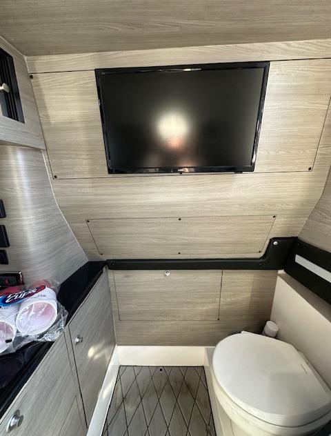 2019 Mystic Powerboats M4200 interior with TV and modern bathroom amenities.