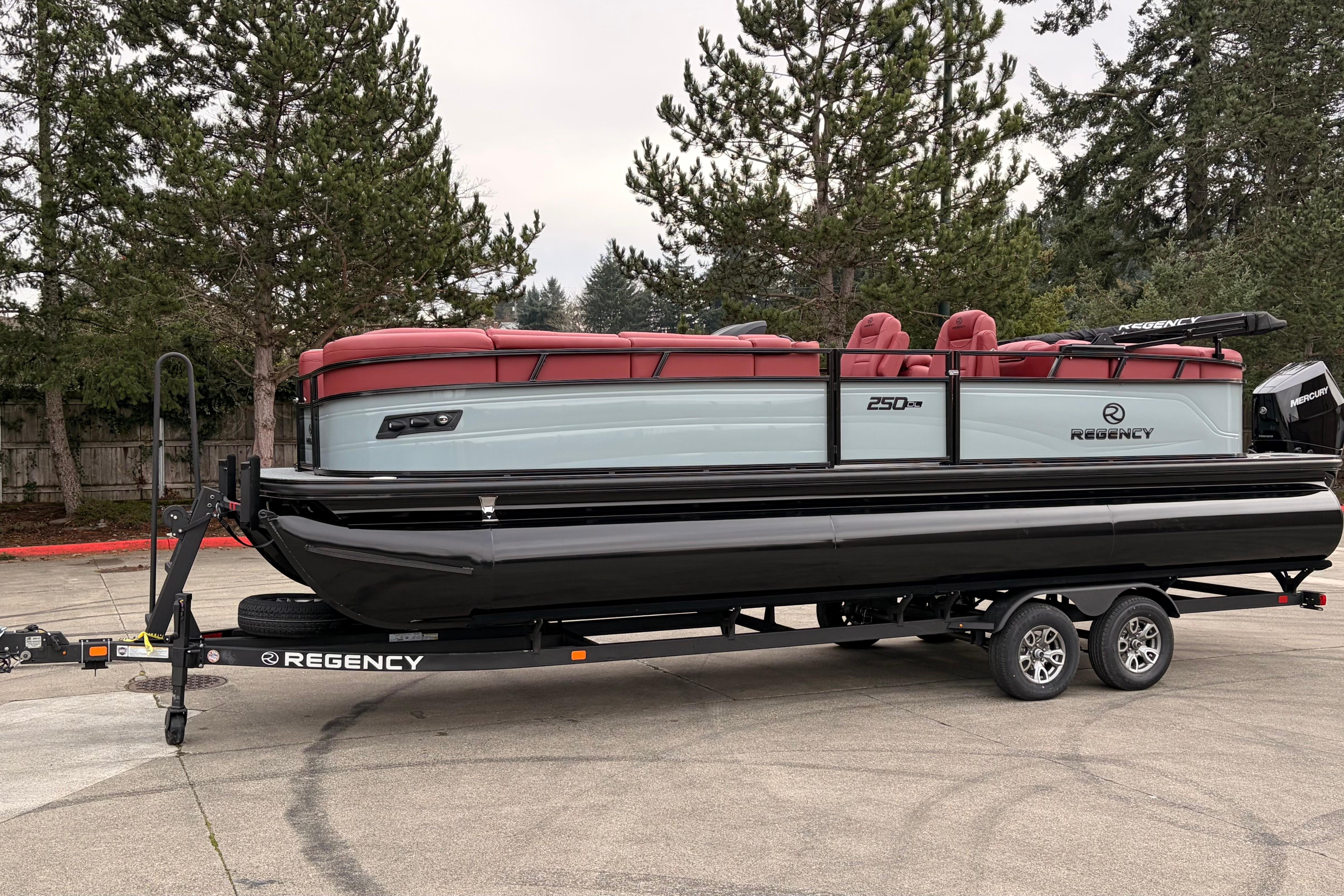 2026 Regency 250 DL pontoon boat on trailer, featuring red seating and sleek design.