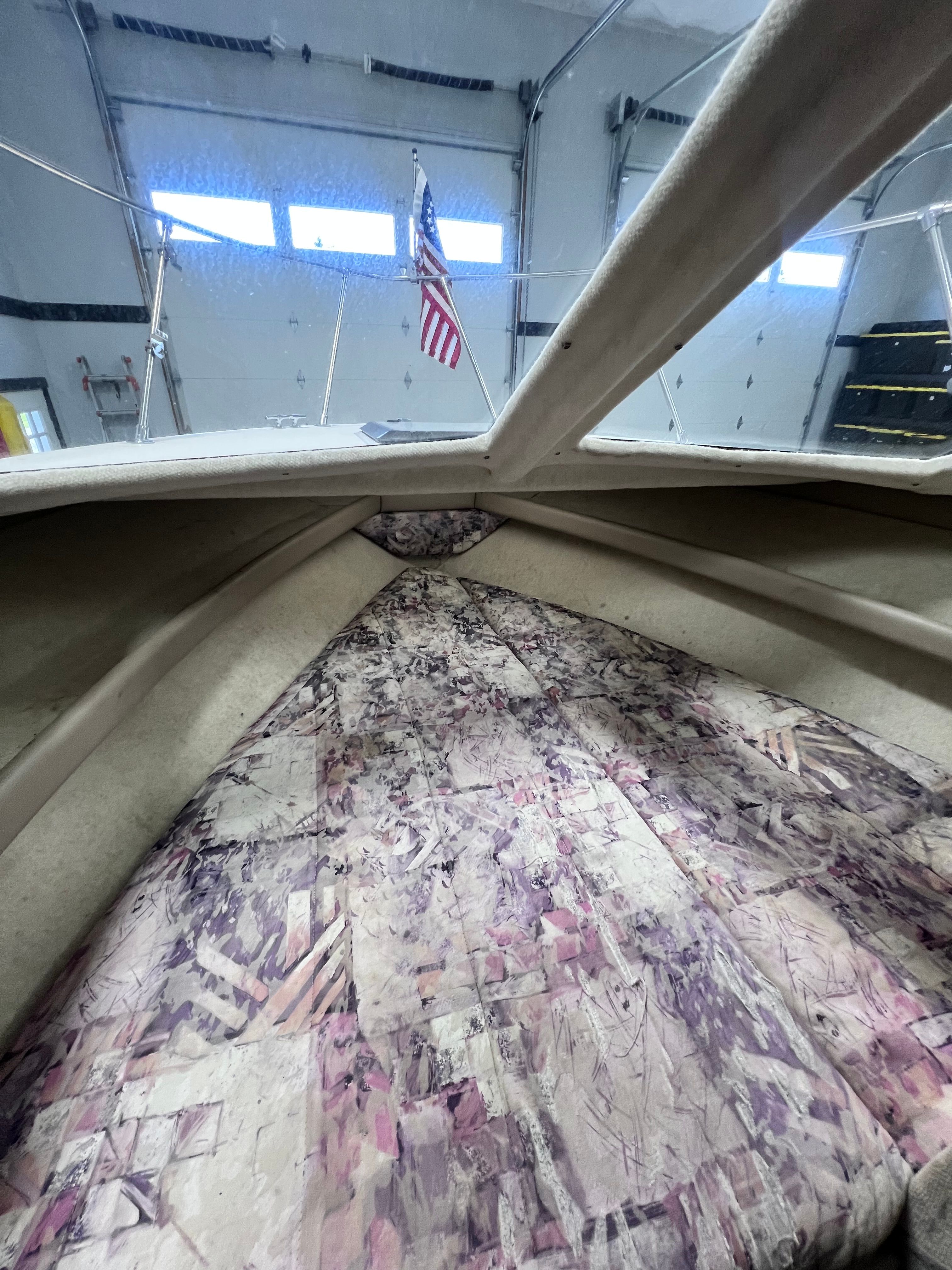 Interior of a 1997 Bayliner 2452 with patterned upholstery.