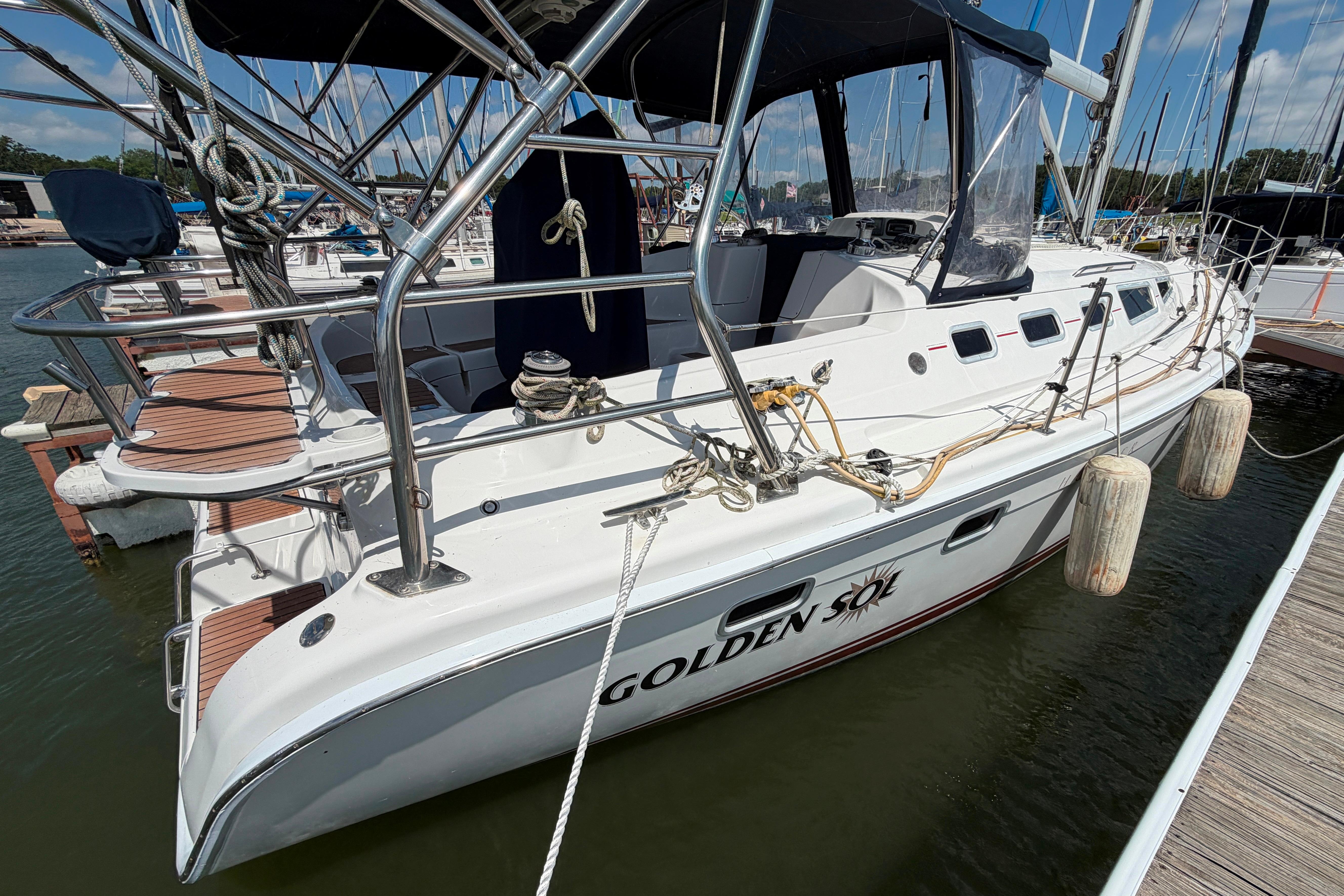 Hunter 38 sailboat from 2005 docked at marina, named "Golden Sol."