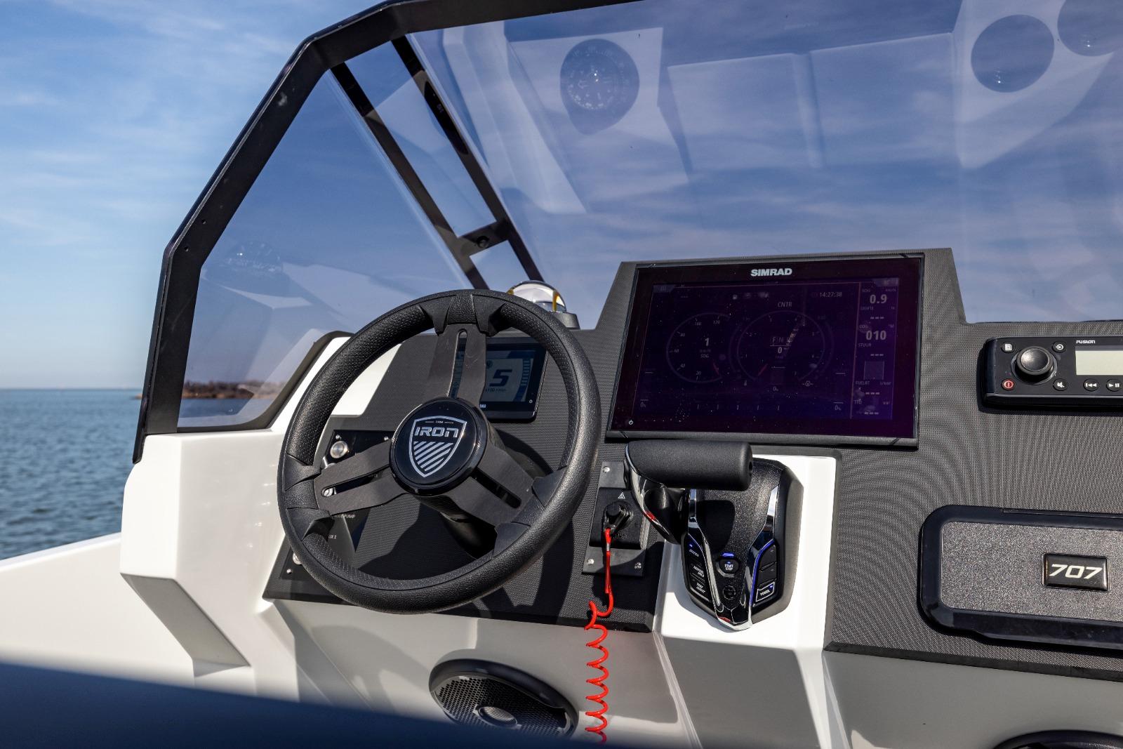 Boat dashboard with Iron 707 steering wheel and navigation display, 2022 model.