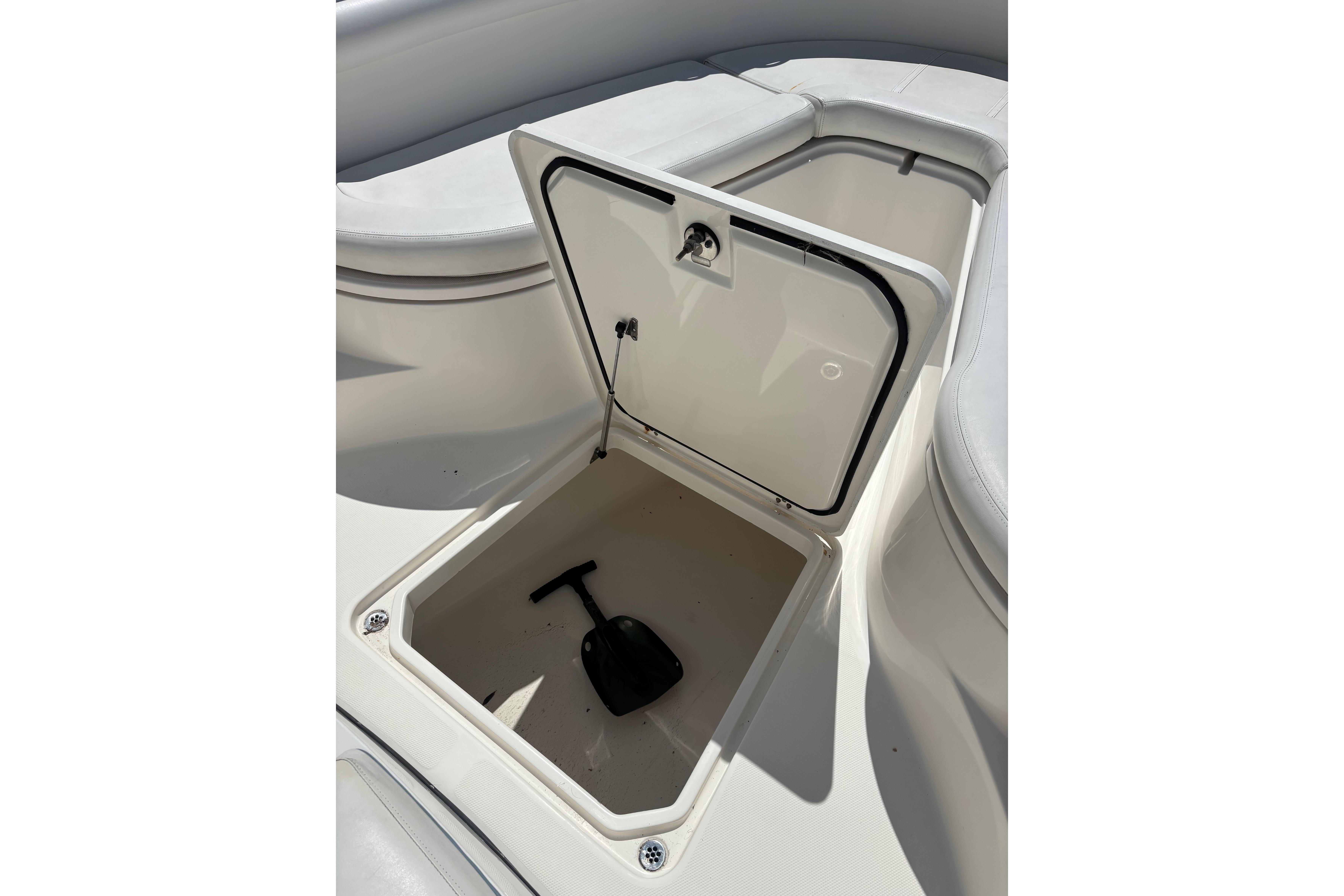 Open storage compartment on a 2006 Edgewater 318CC boat, showcasing interior space.