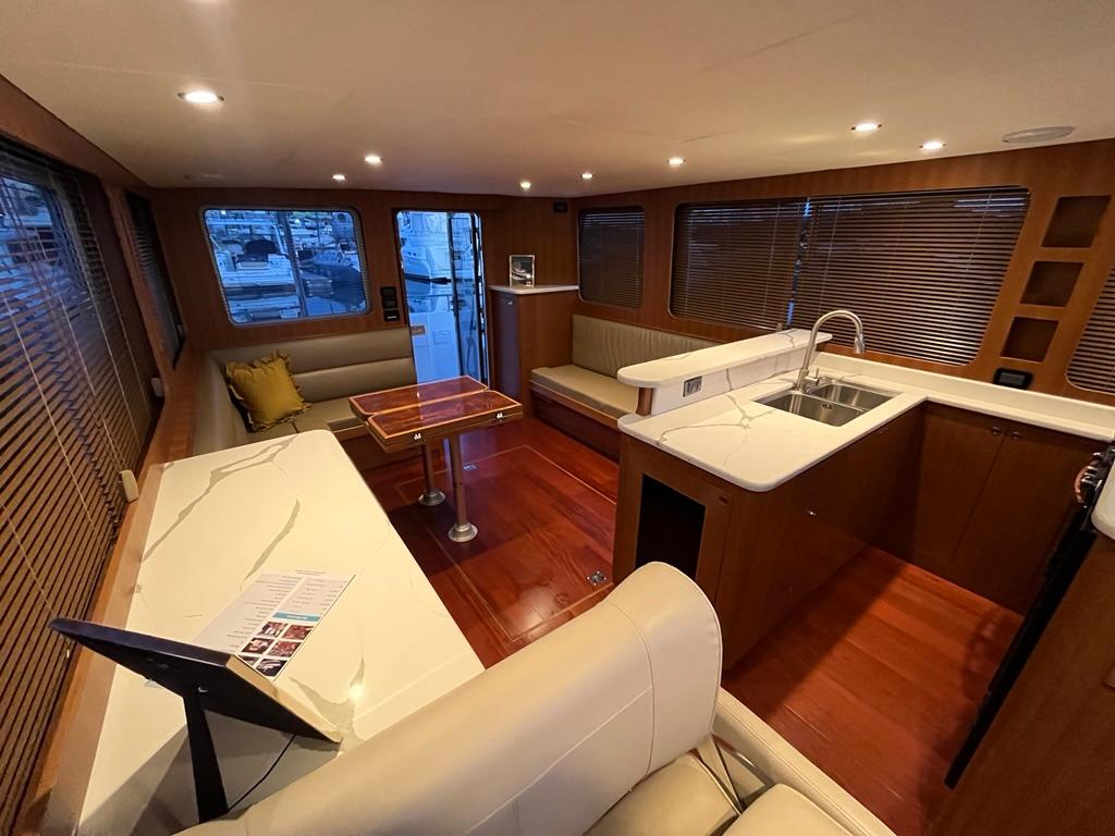 Luxurious interior of 2025 Bracewell 41 yacht with modern kitchen and seating area.