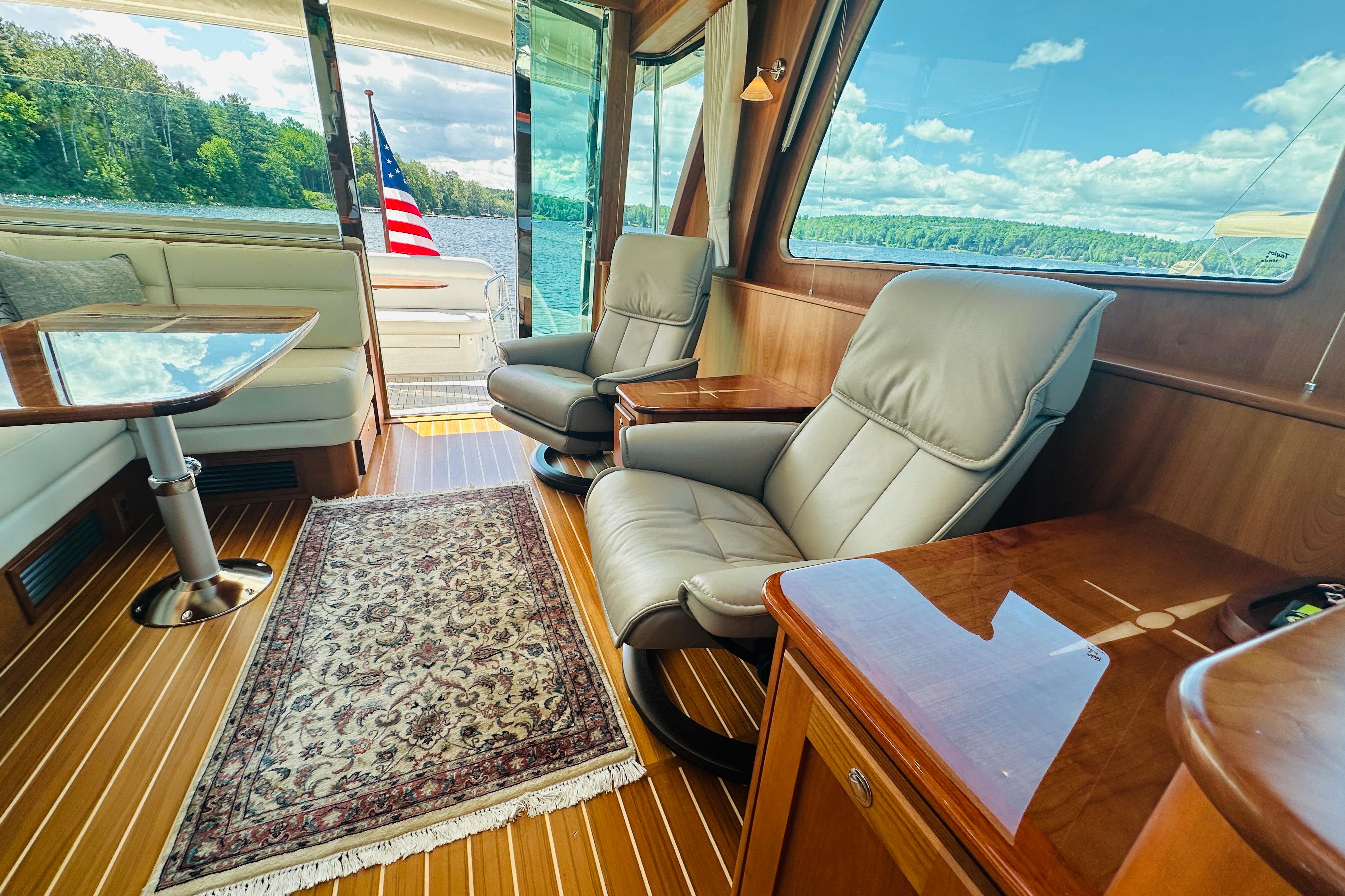 Luxurious interior of 2025 Sabre 48 Salon Express yacht with leather seating and scenic view.