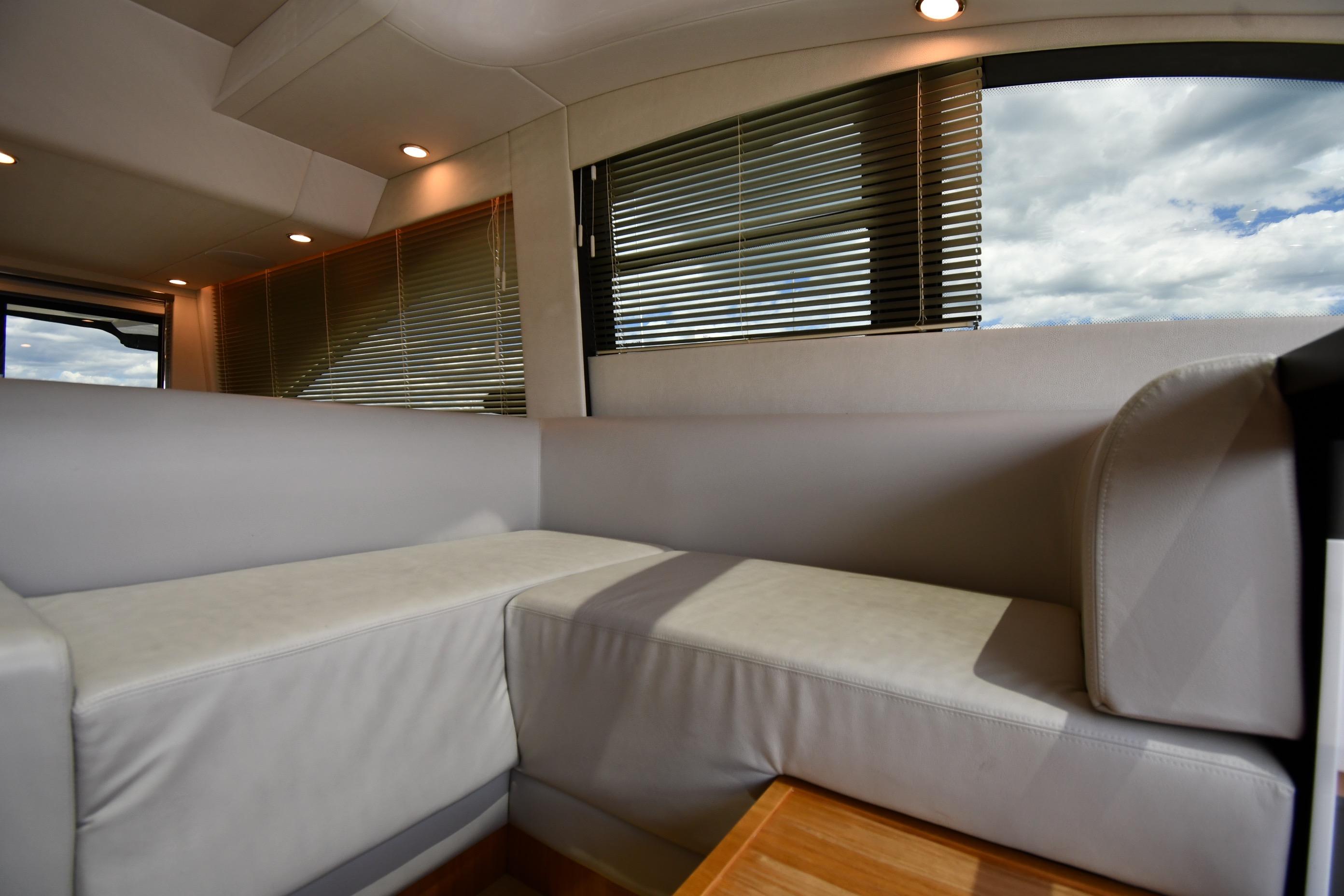 Luxurious interior of 2024 Fairline G50 Targa yacht with modern seating and large windows.