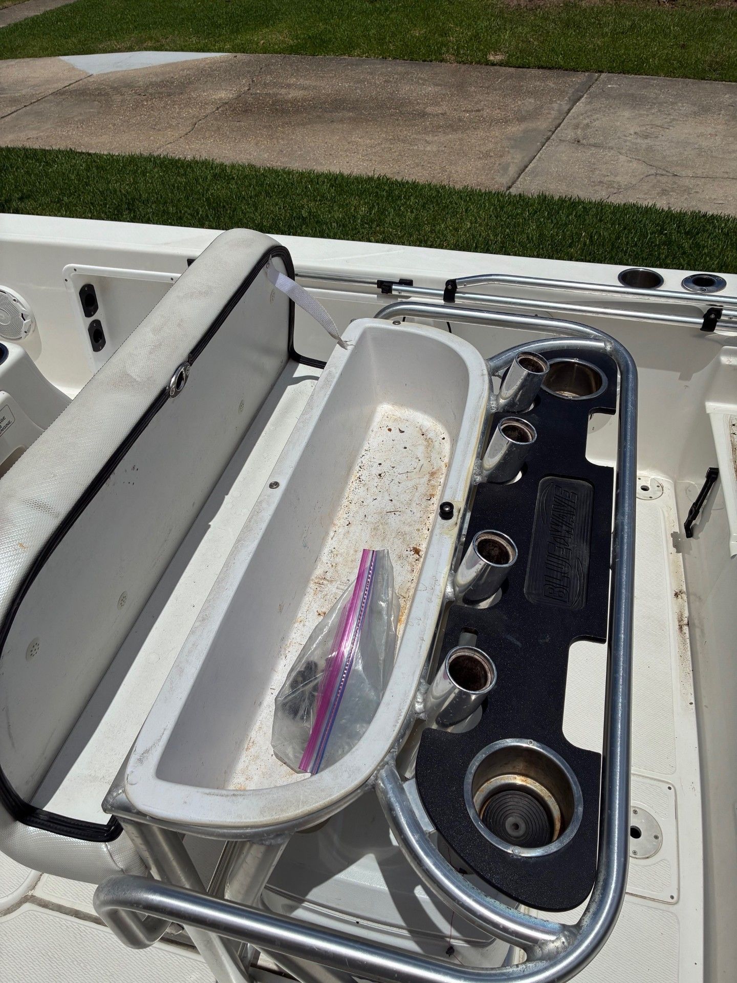 The image shows the cockpit of a 2018 Custom 2200 Pure Bay boat with fishing rod holders.