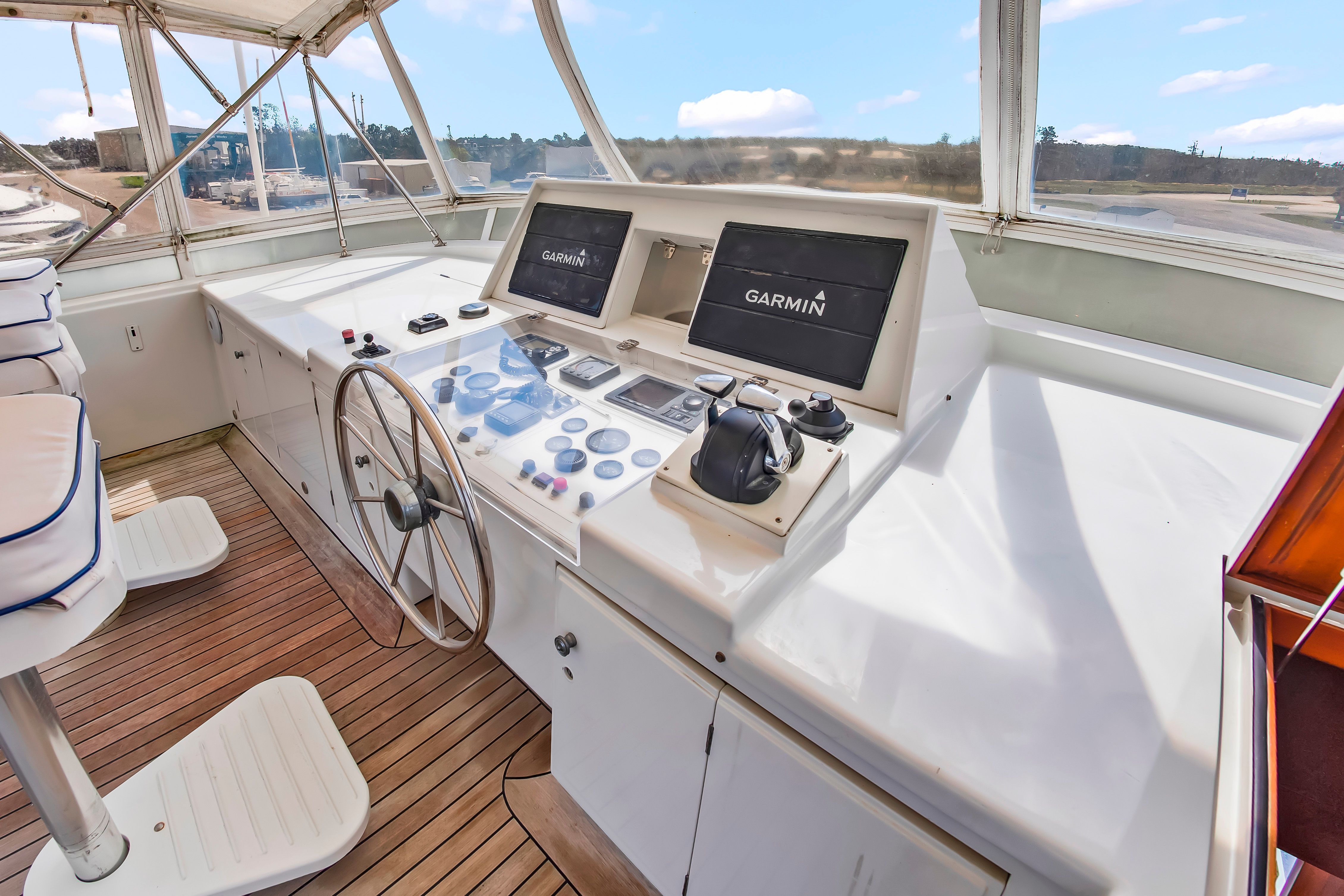 The image shows the helm of a 1987 Jongert 78 Motor Yacht with modern navigation systems.