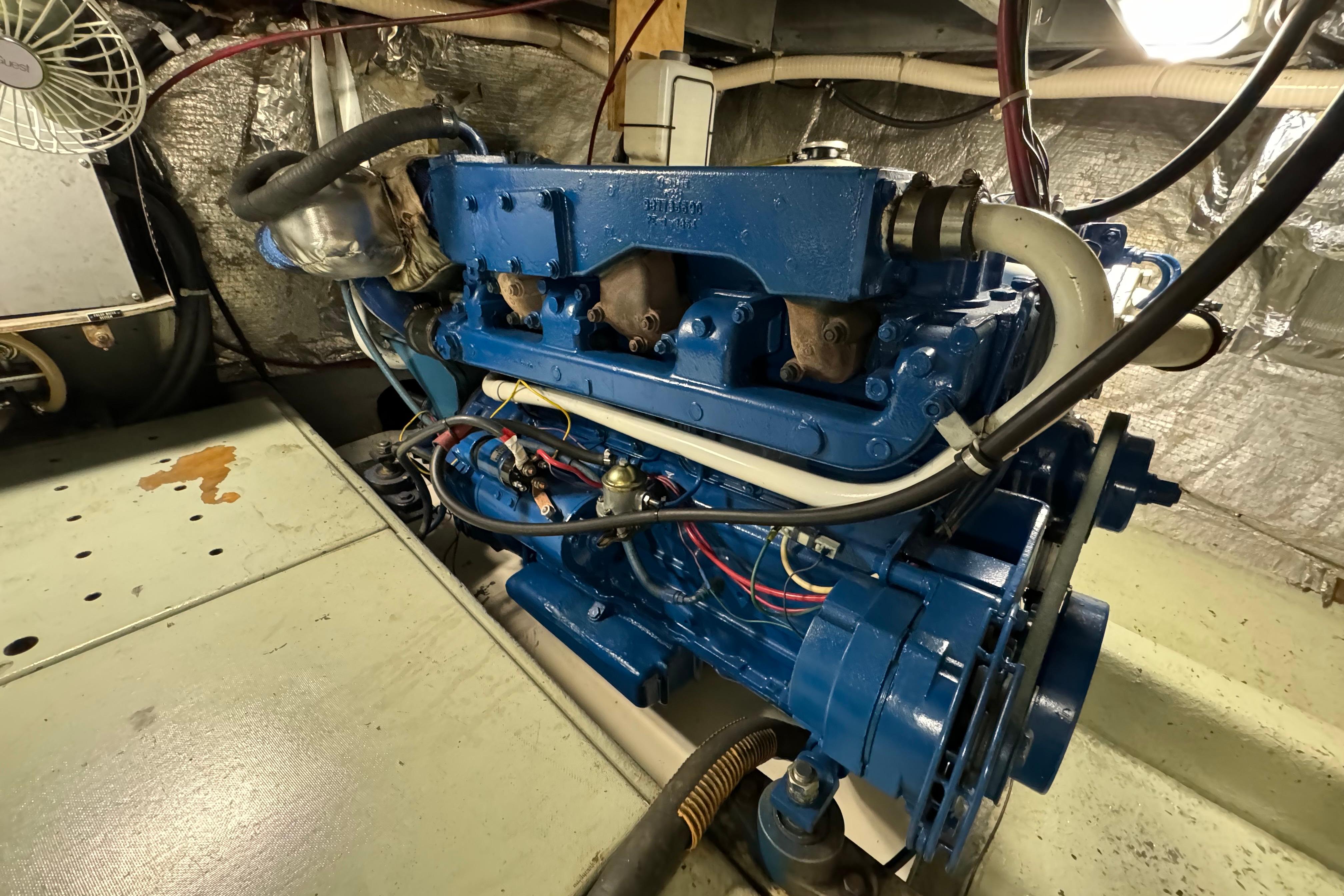 Blue engine in a 1978 Californian 42 LRC boat, detailed view in engine room.