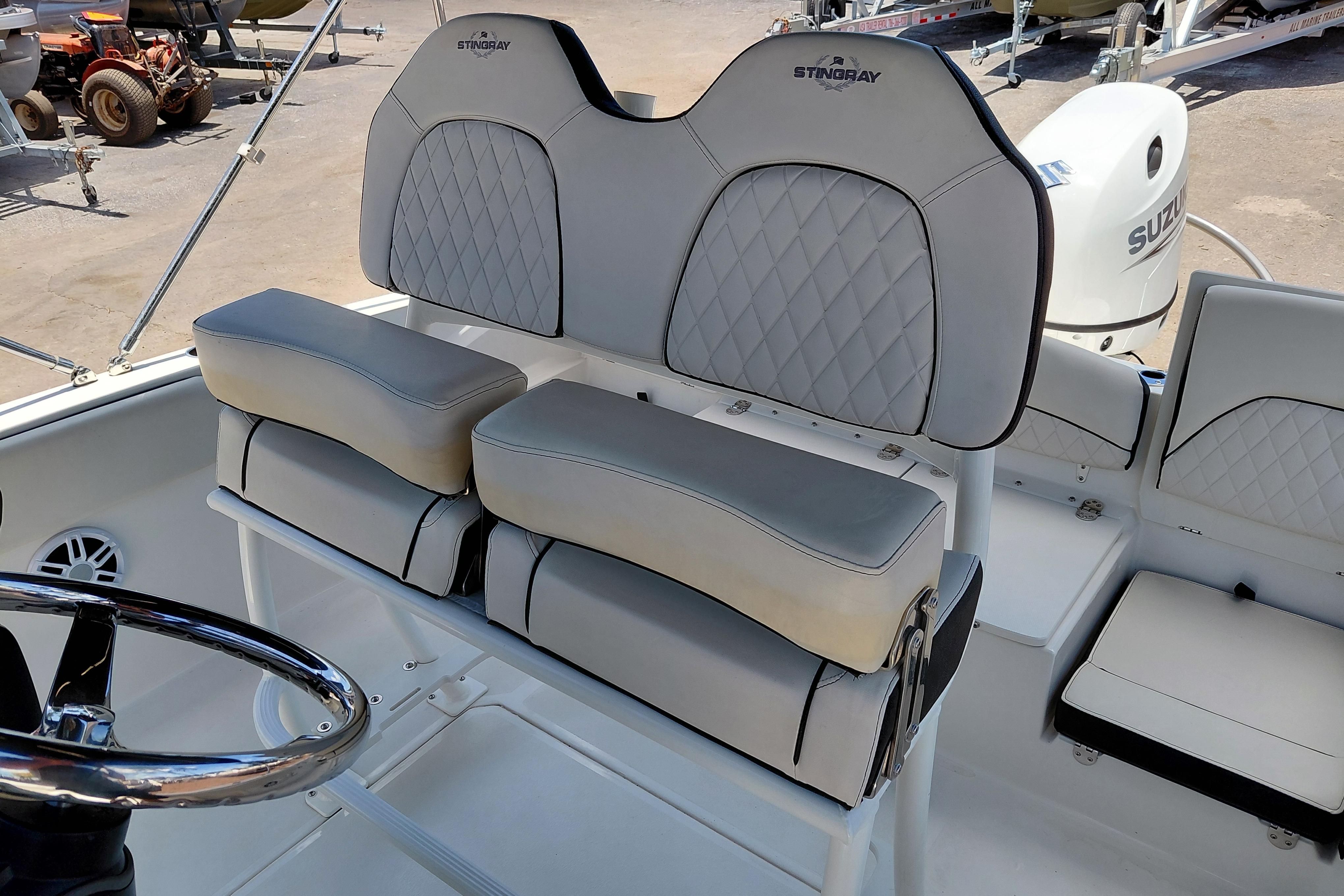 2023 Stingray 206 CC boat interior with cushioned seating and steering wheel.
