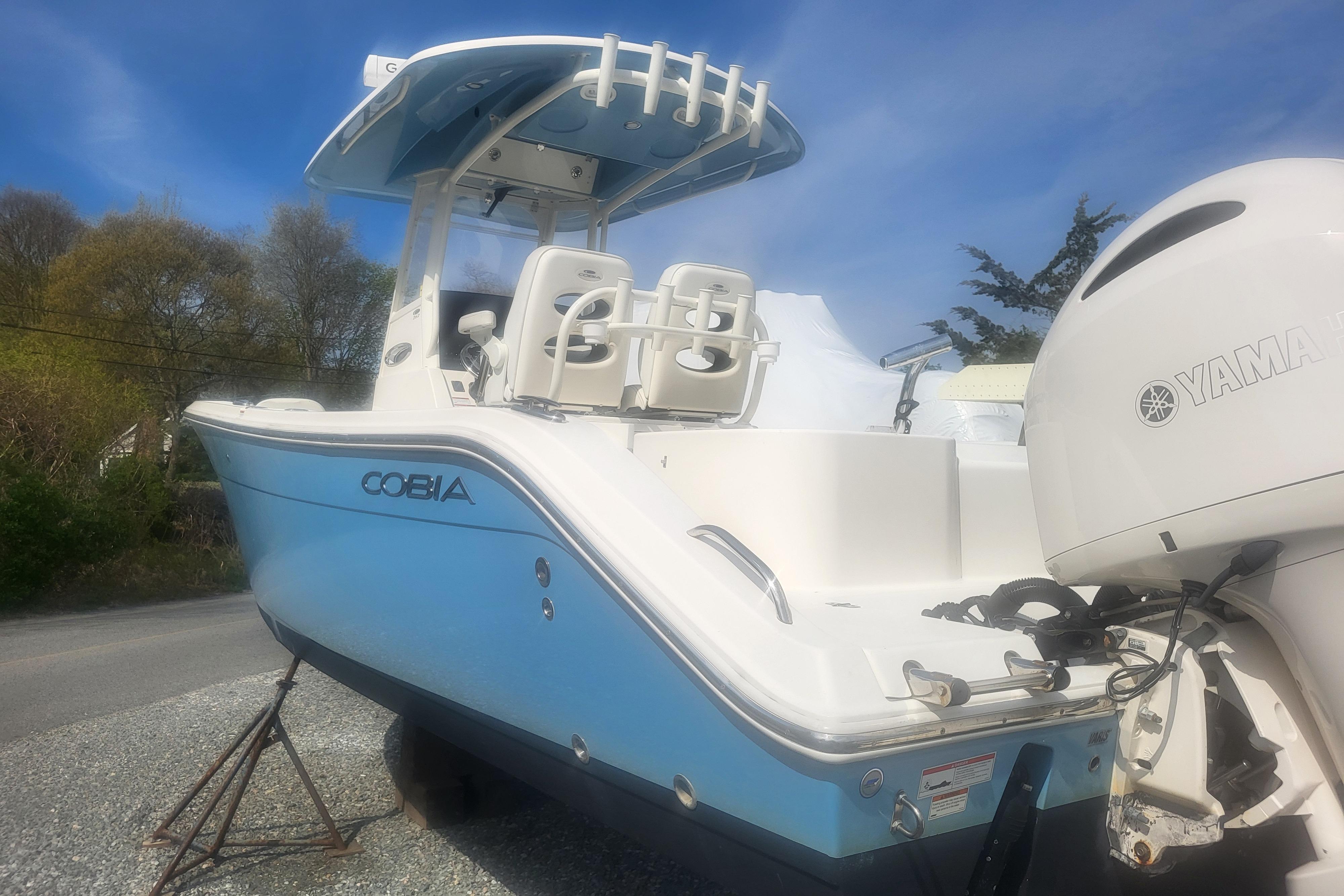 2022 Cobia 262 Center Console boat with Yamaha engine, parked outdoors.