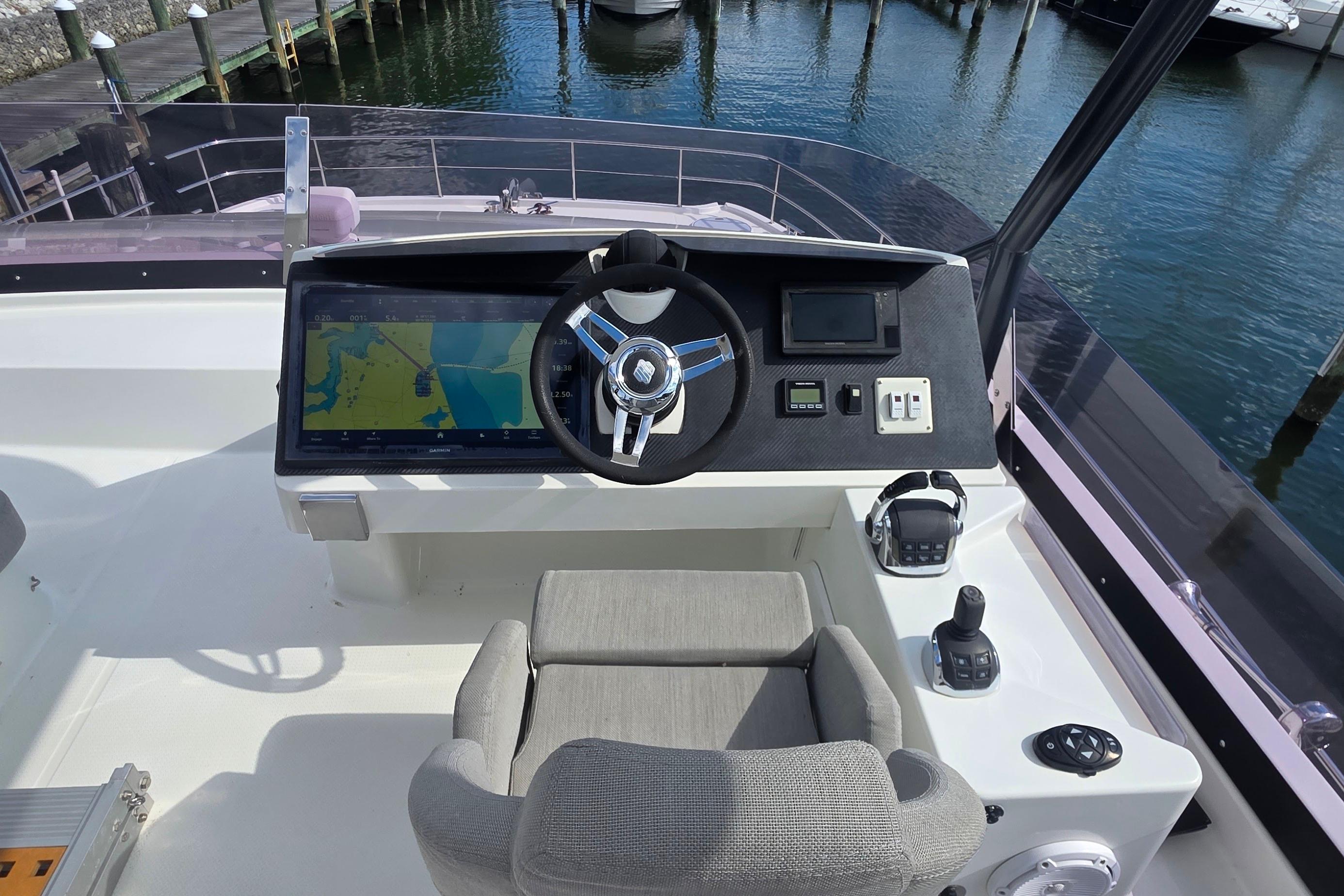 Cockpit of 2018 Fountaine Pajot Motor Yacht 44 with navigation controls and steering wheel.