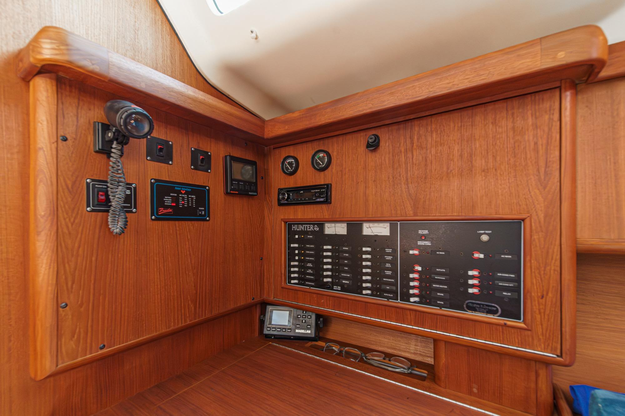 Control panel of a 1996 Hunter 376 sailboat with wooden interior.