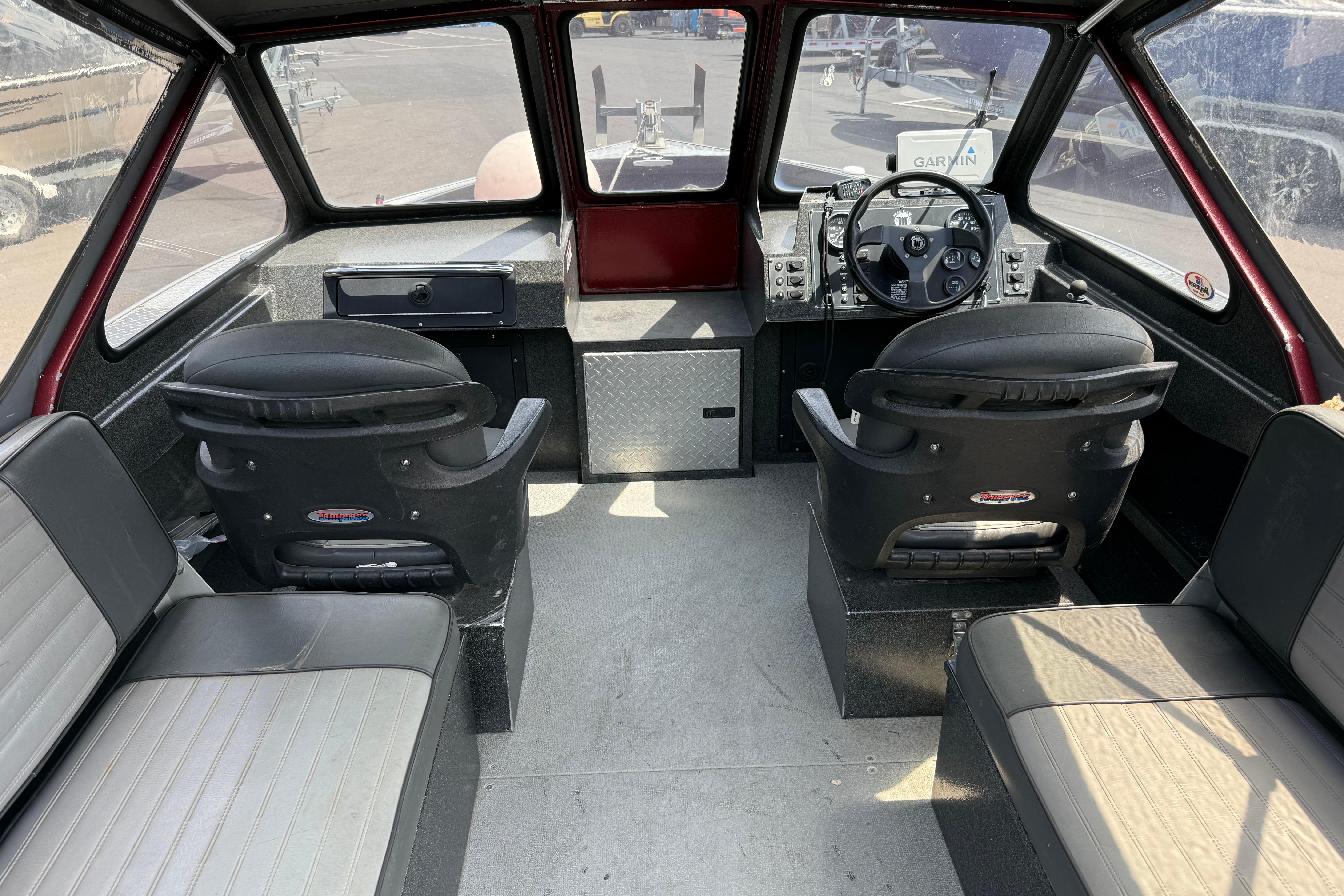 Interior of a 2005 Willie Raptor 21' boat with seating and steering console.