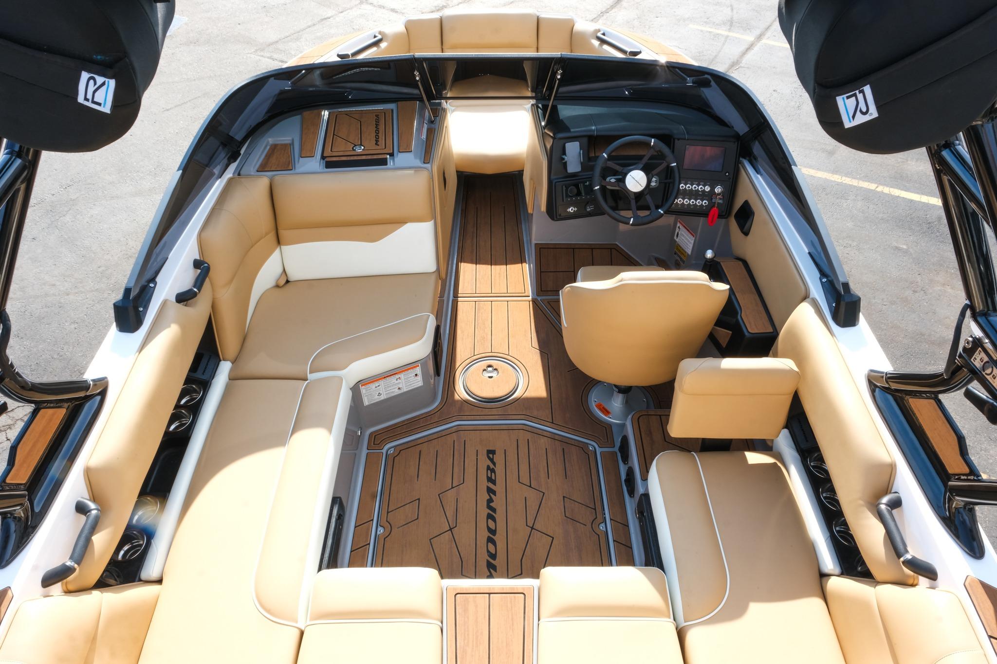 2023 Moomba Mondo boat interior with tan seating and sleek dashboard design.