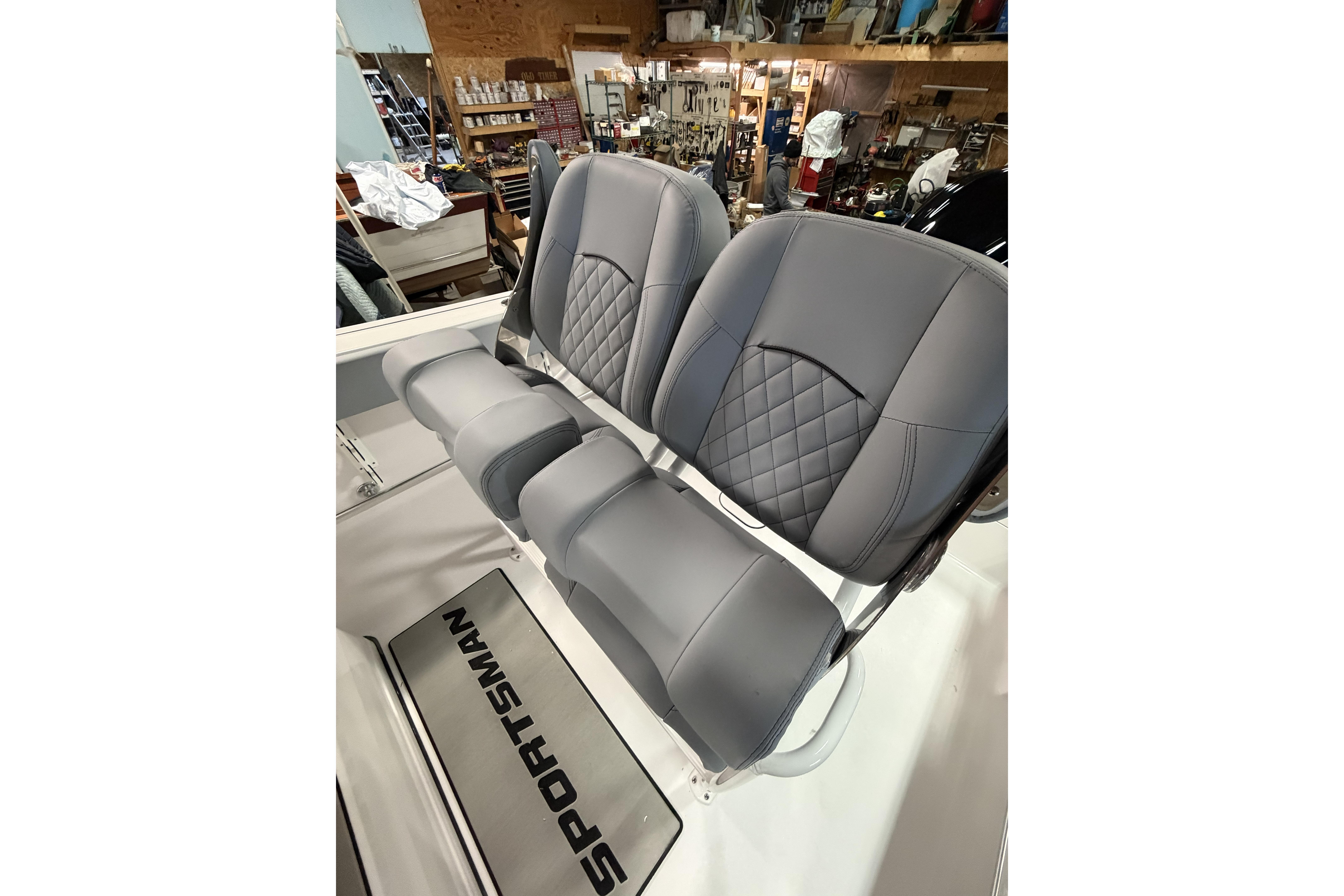 2026 Sportsman Open 232 Center Console boat seats in a workshop setting.