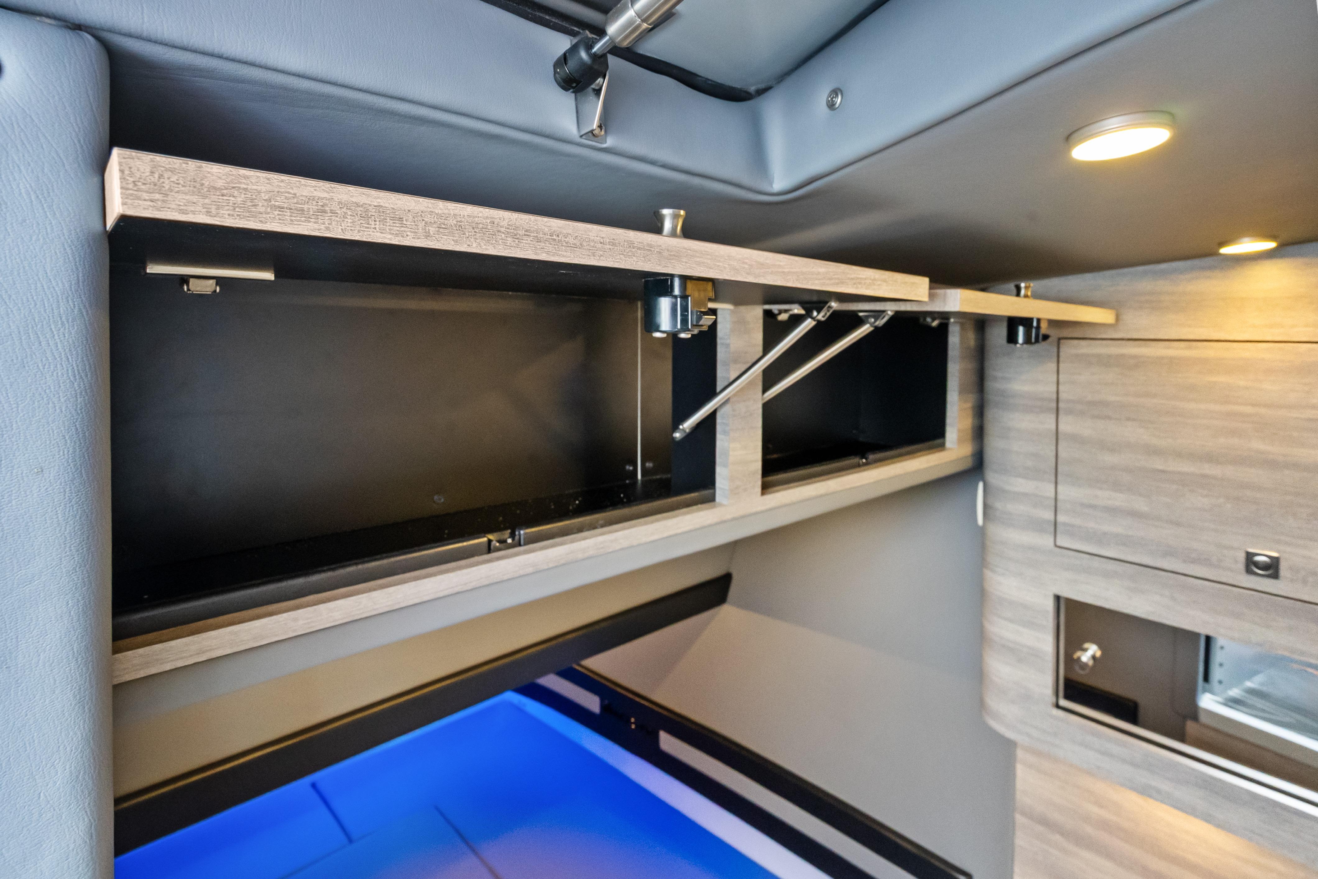 Interior storage compartment of 2027 Mystic Powerboats M4200, featuring modern design and lighting.