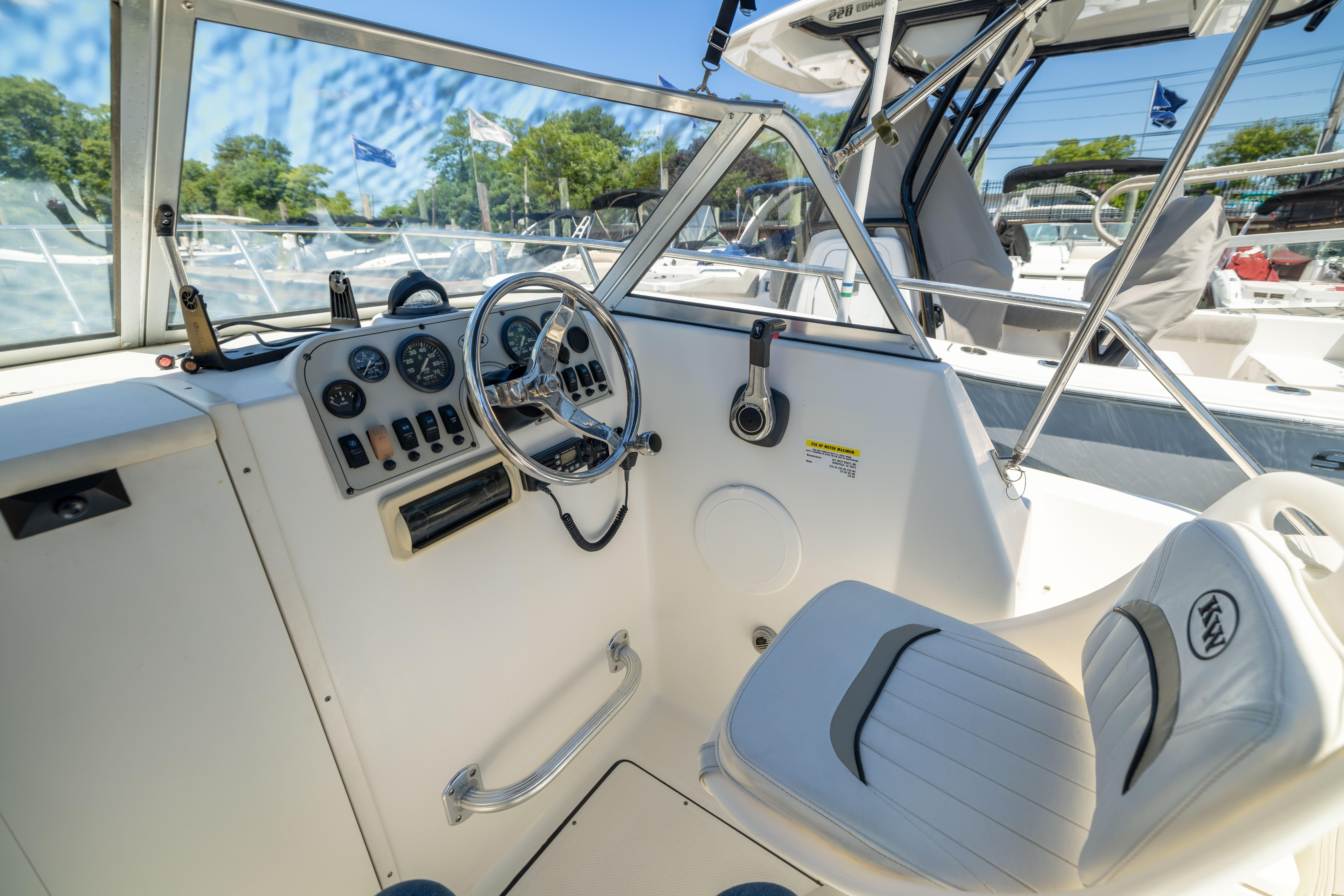 Interior view of a 2012 KEYWEST 2020 WA boat cockpit with steering wheel and controls.