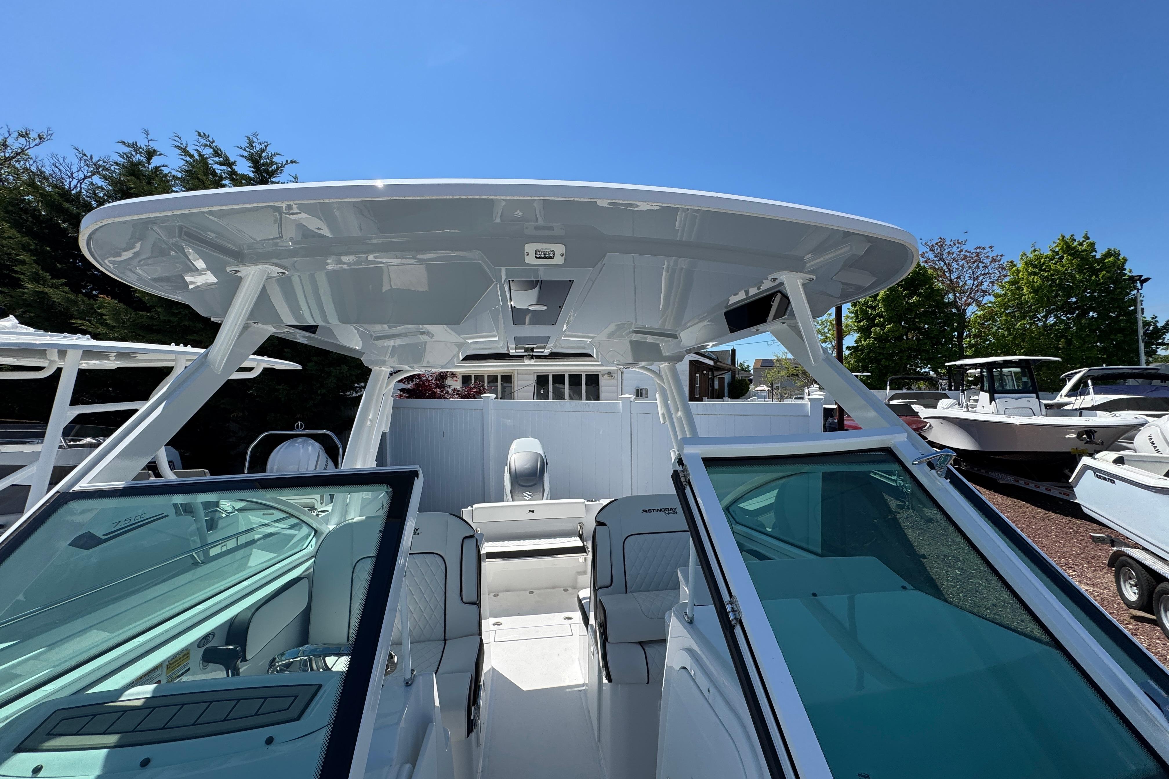 2026 Stingray 259 DC boat with sleek design and spacious seating under a clear blue sky.