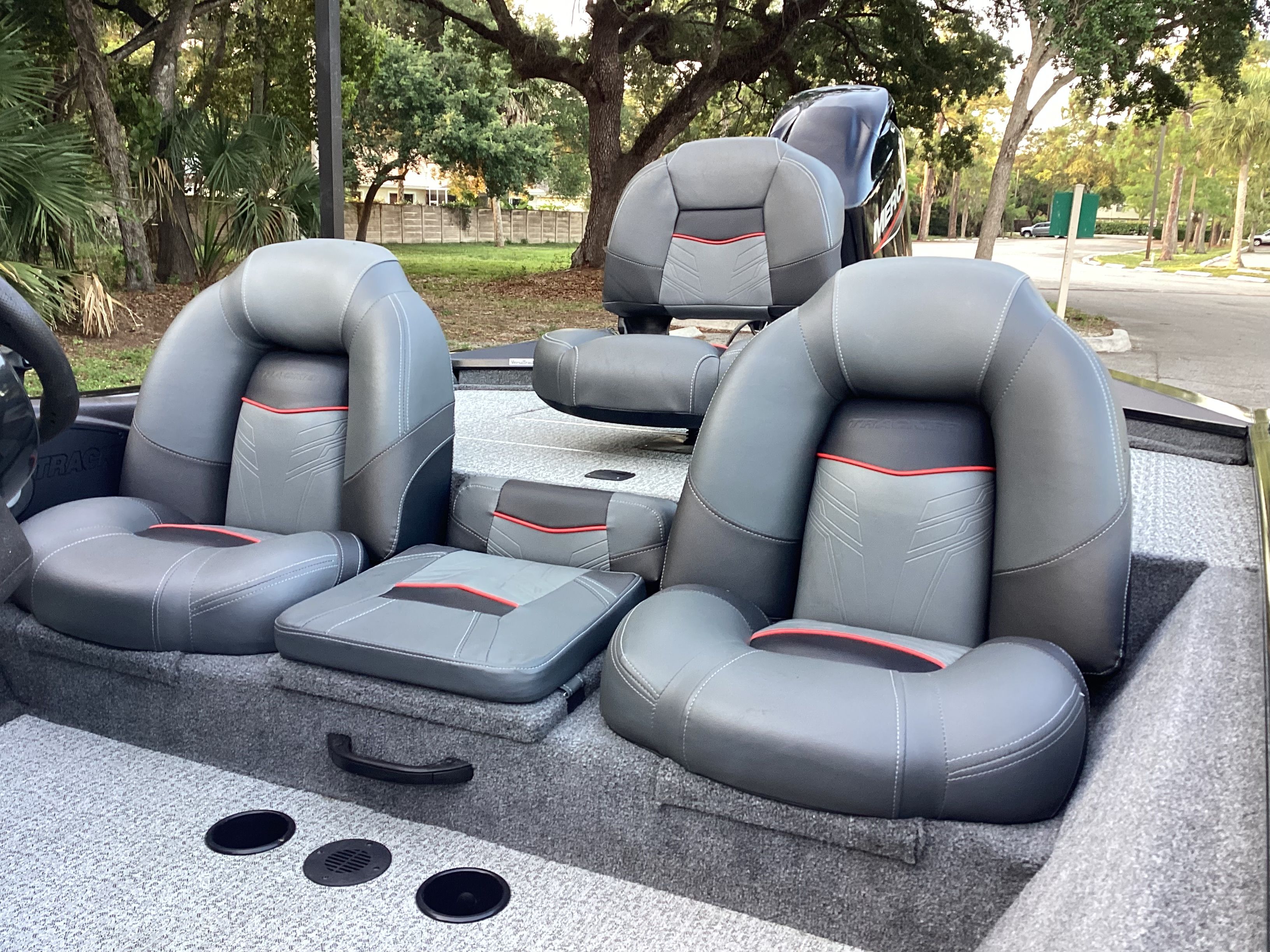 Tracker PRO 2023 boat with gray seats outdoors.