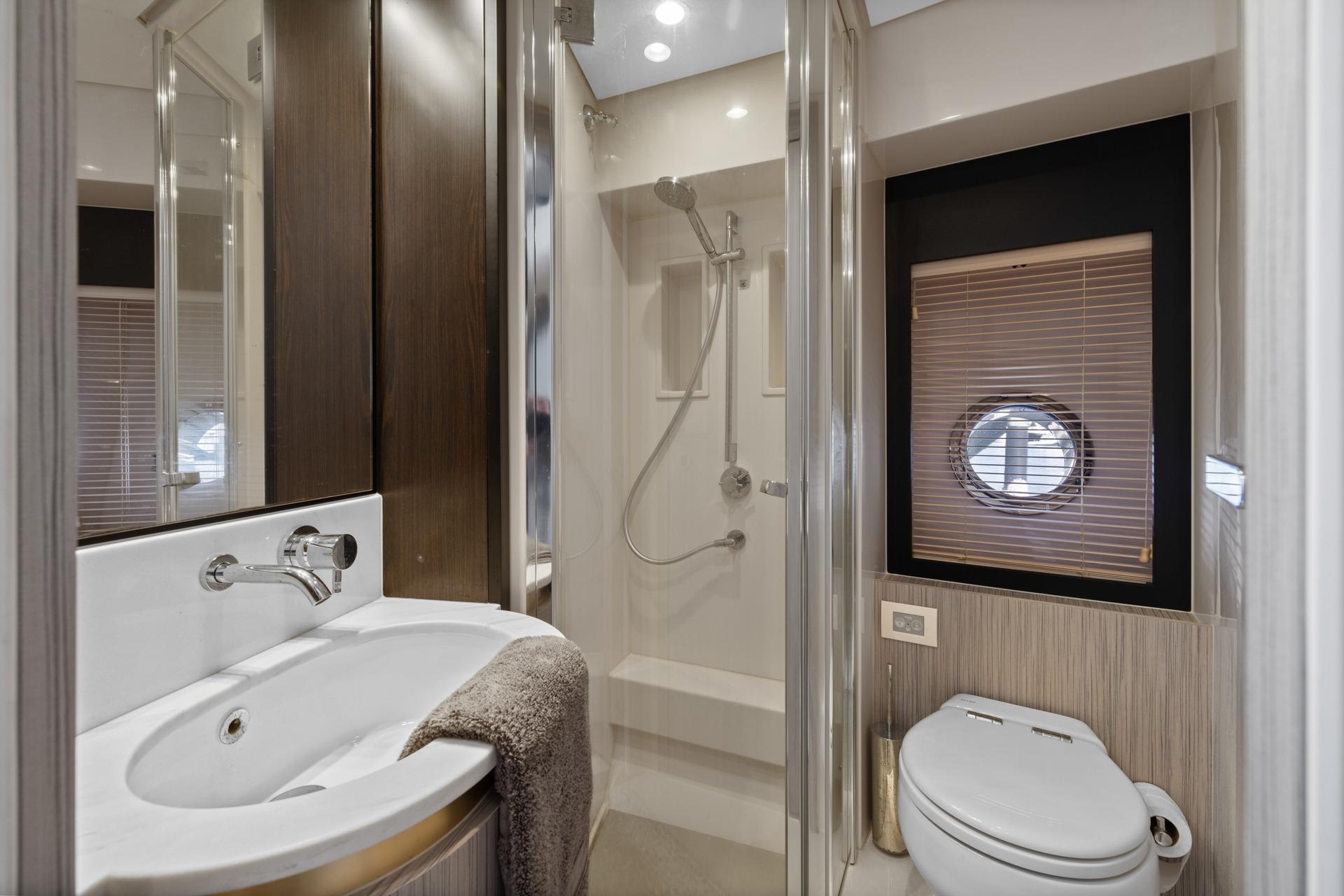 Luxurious bathroom in 2019 Azimut 55 yacht with modern fixtures and elegant design.