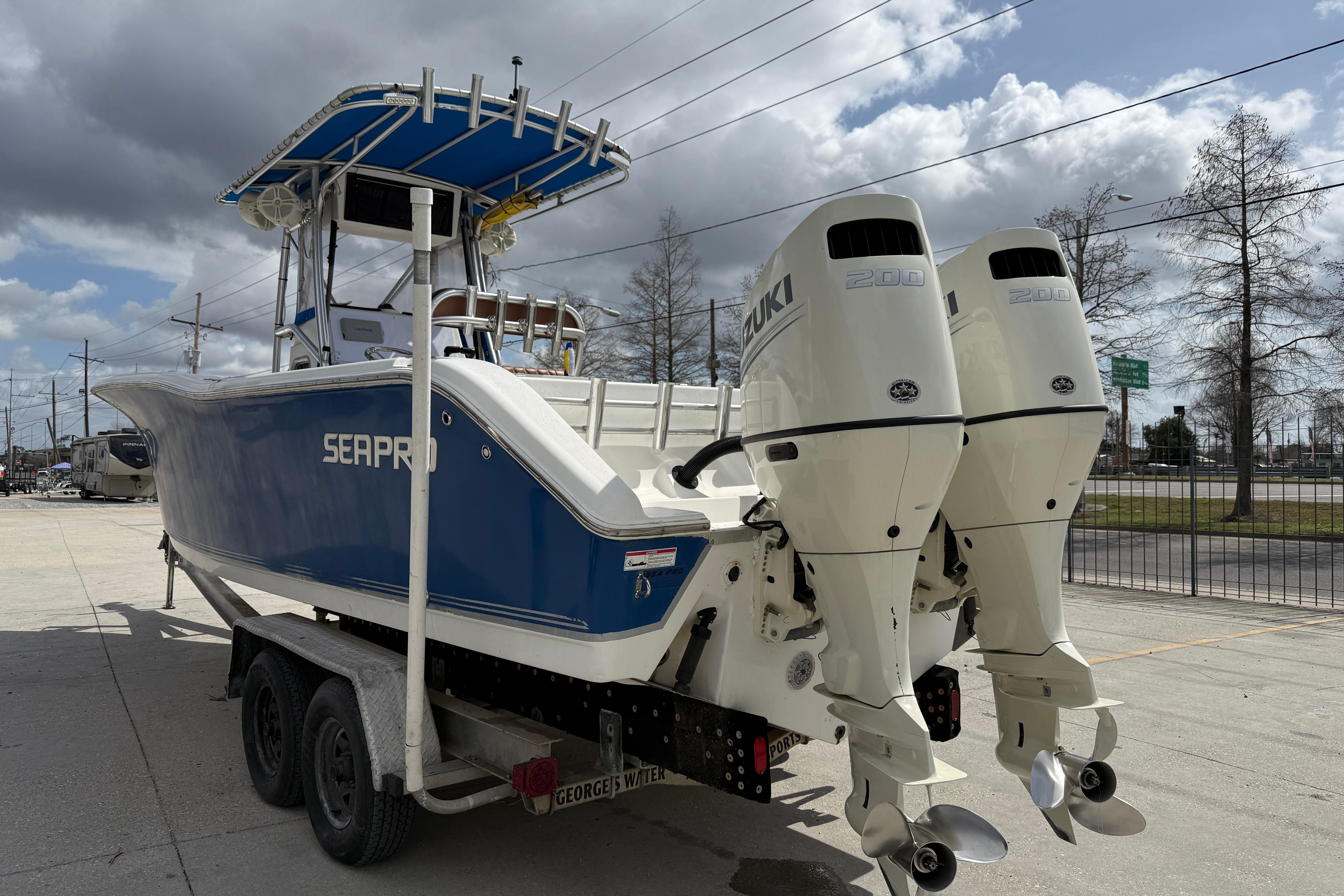2007 Sea Pro 270 Center Console boat with dual Suzuki engines on a trailer.