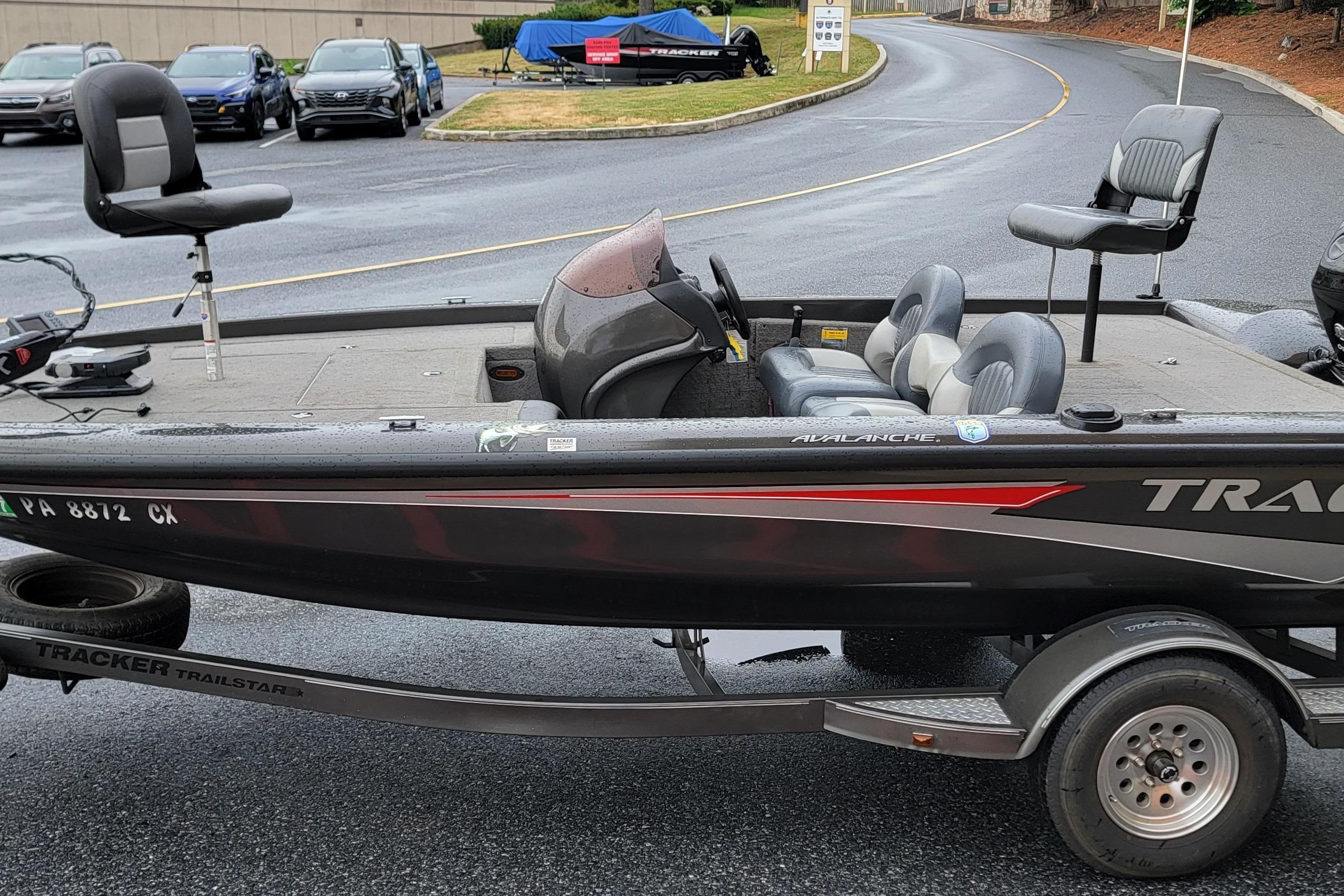 2006 Tracker Avalanche 18 SC fishing boat on trailer in parking lot.