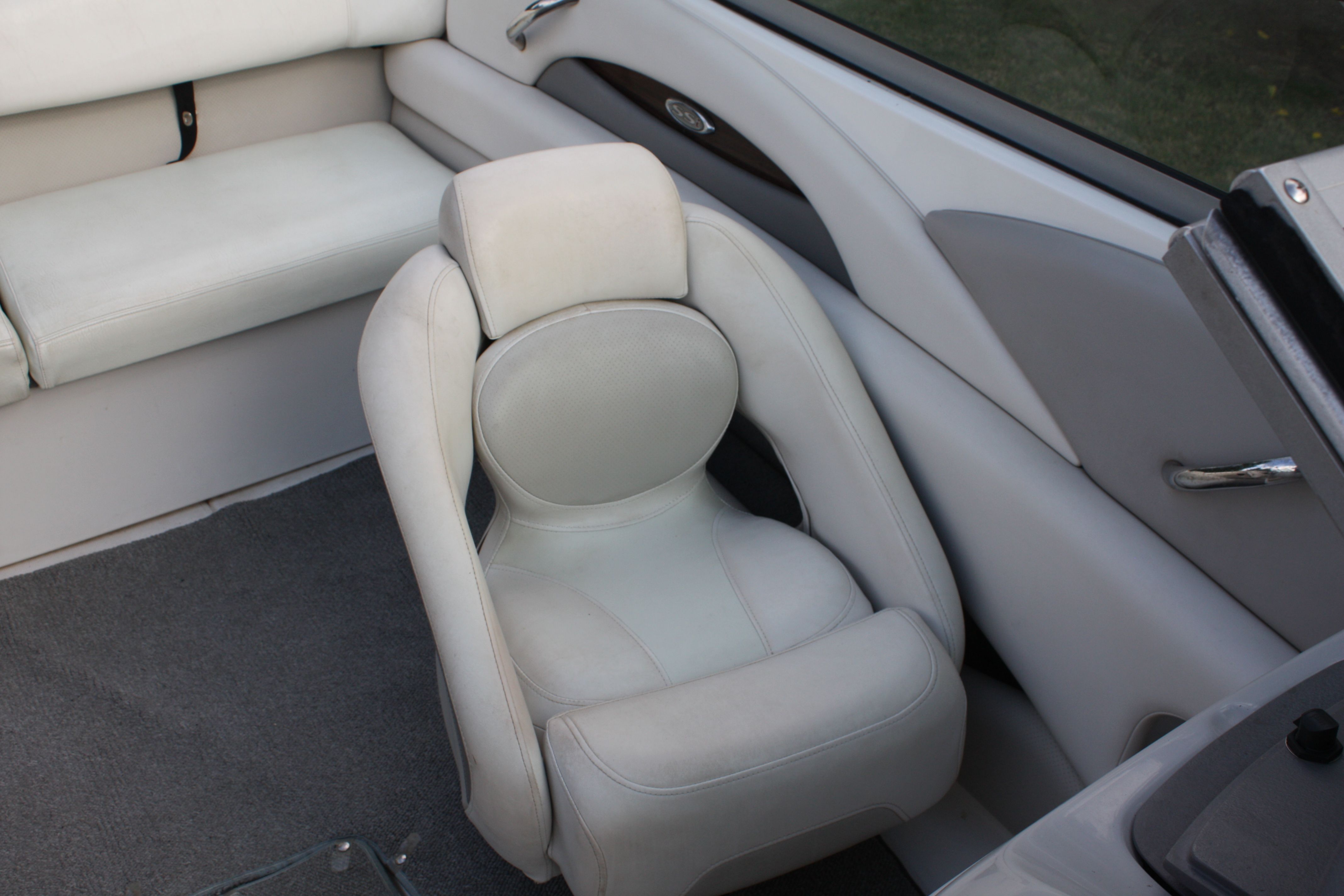 Interior of a 2007 Chaparral 210 SSi with gray upholstery and a cushioned seat.