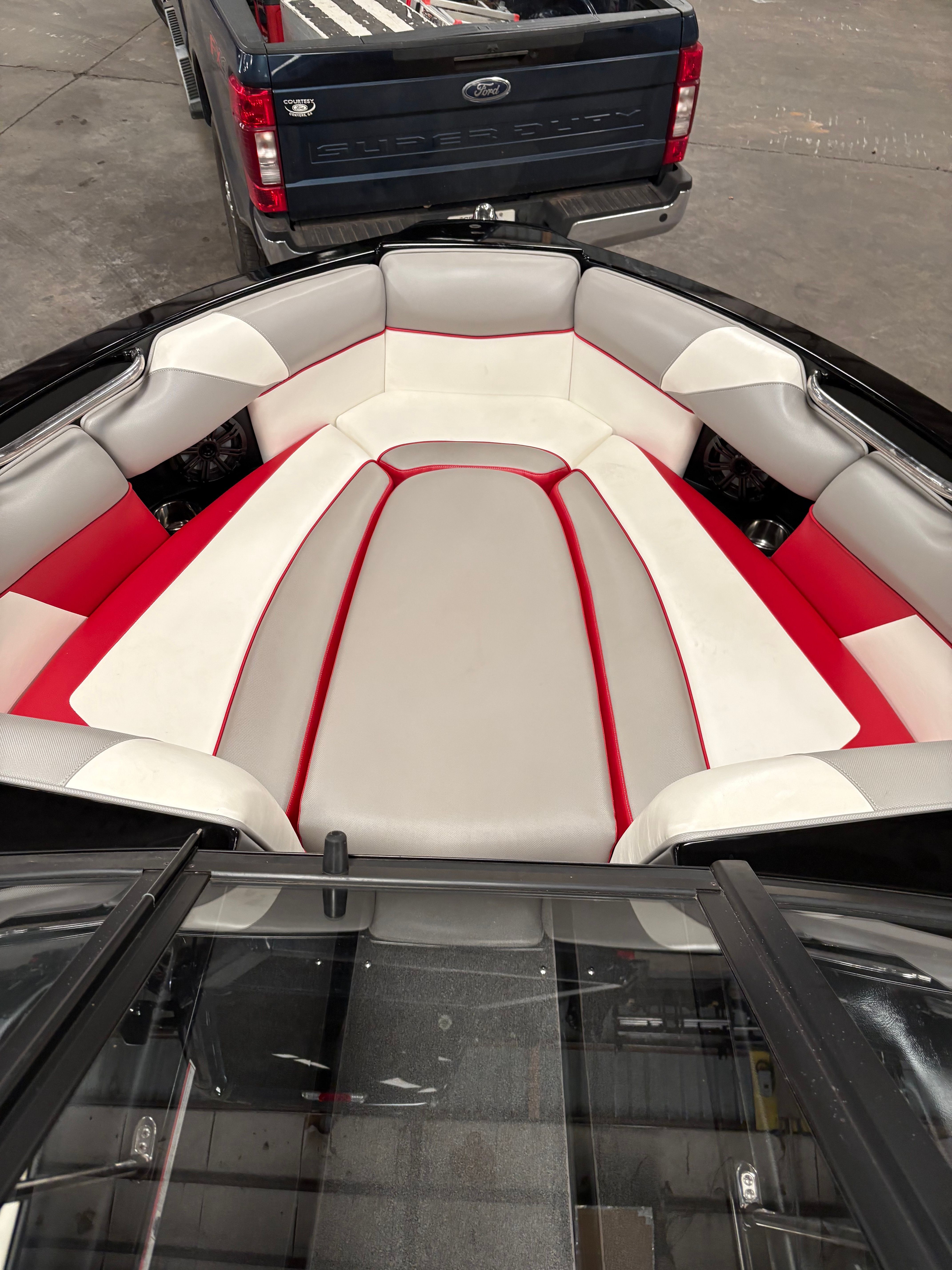 Interior of a 2019 Moomba Craz boat with red and gray seating.