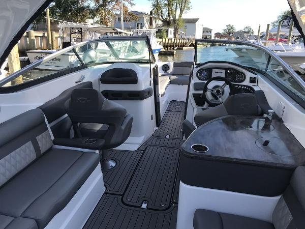 2020 Rinker 29QX BR boat interior with seating, steering wheel, and dashboard.