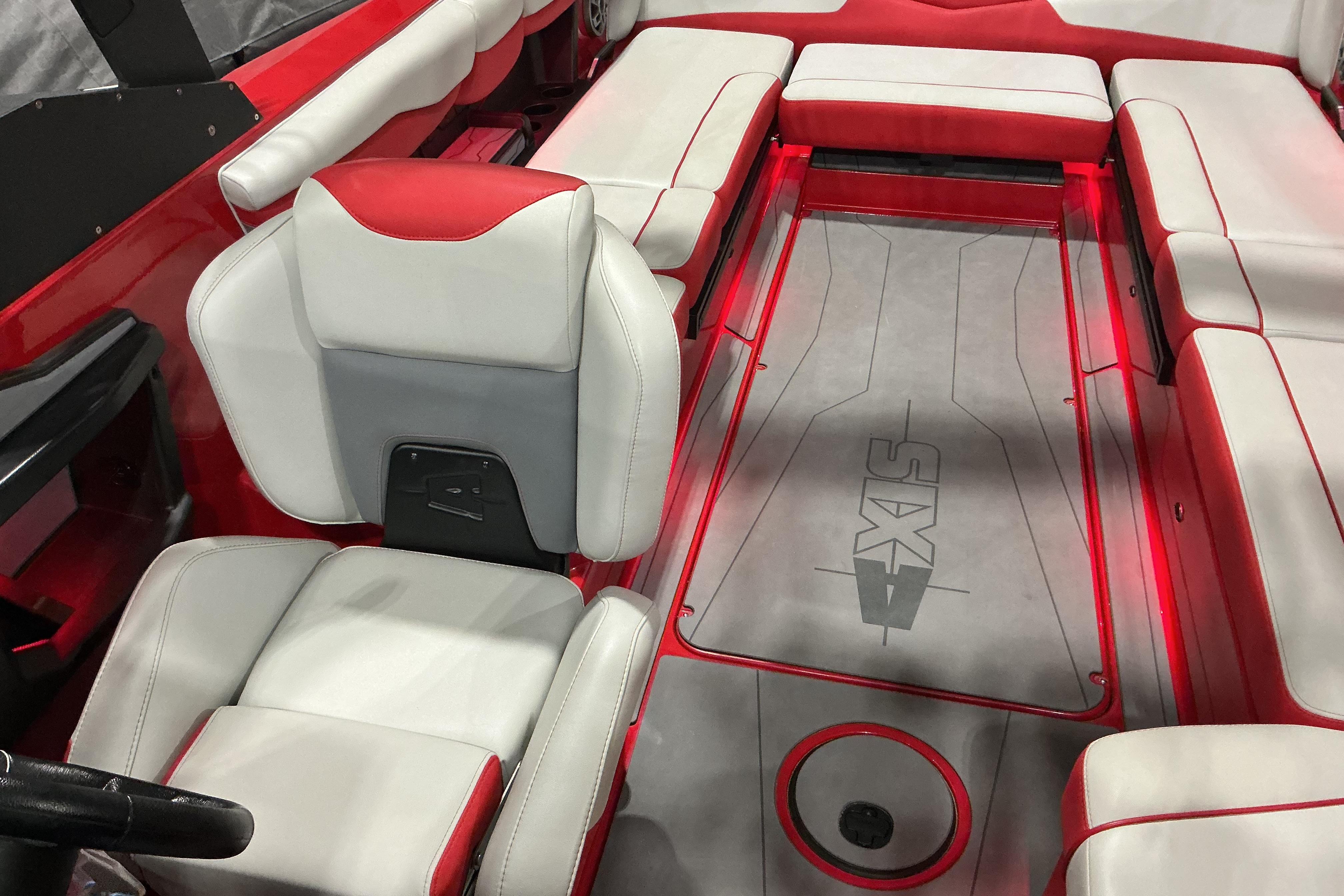 2022 Axis T250 boat interior with red and white seating and branded flooring.