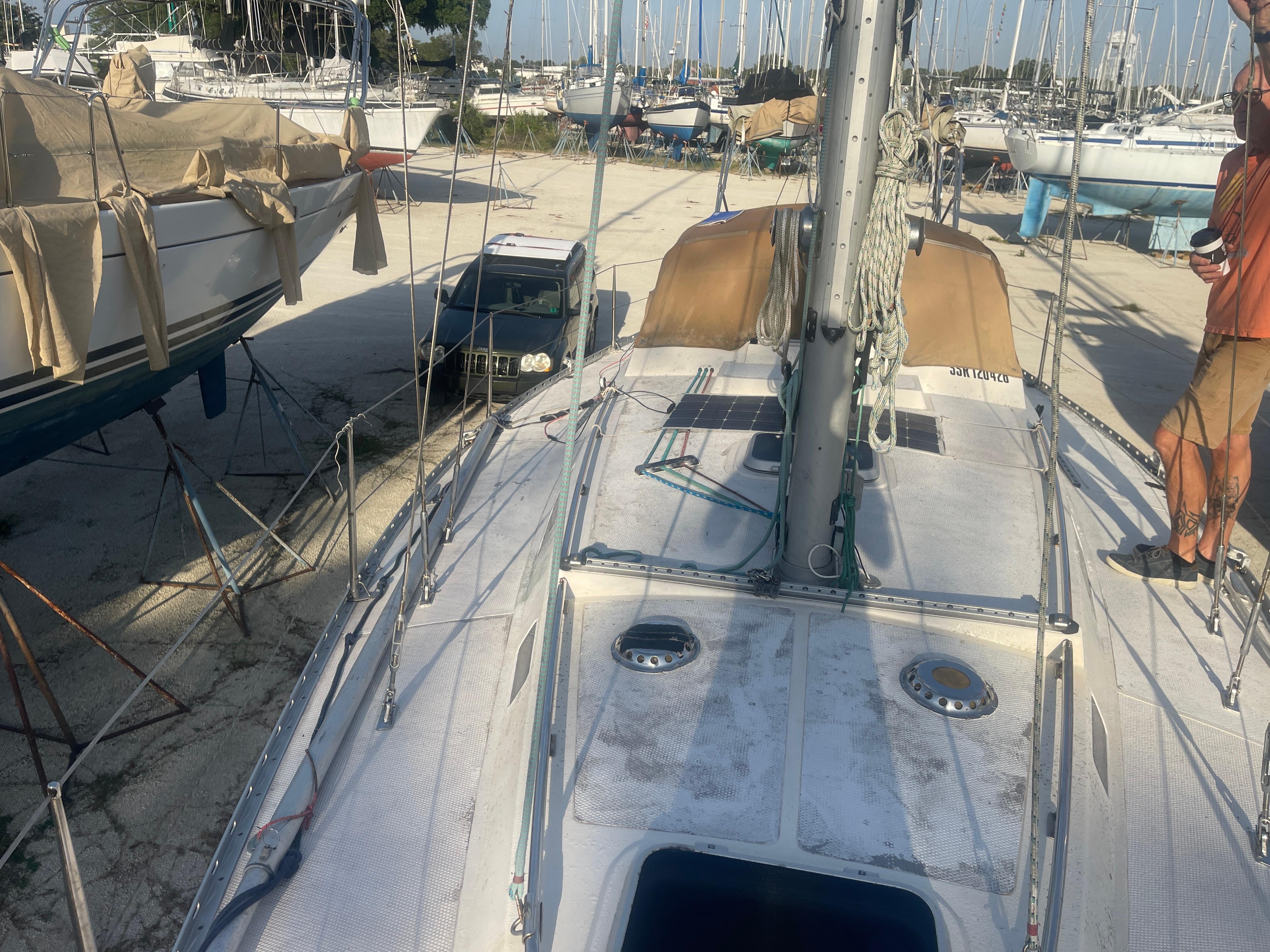 1984 Hanseat 37 sailboat on dry dock, surrounded by other boats and equipment.