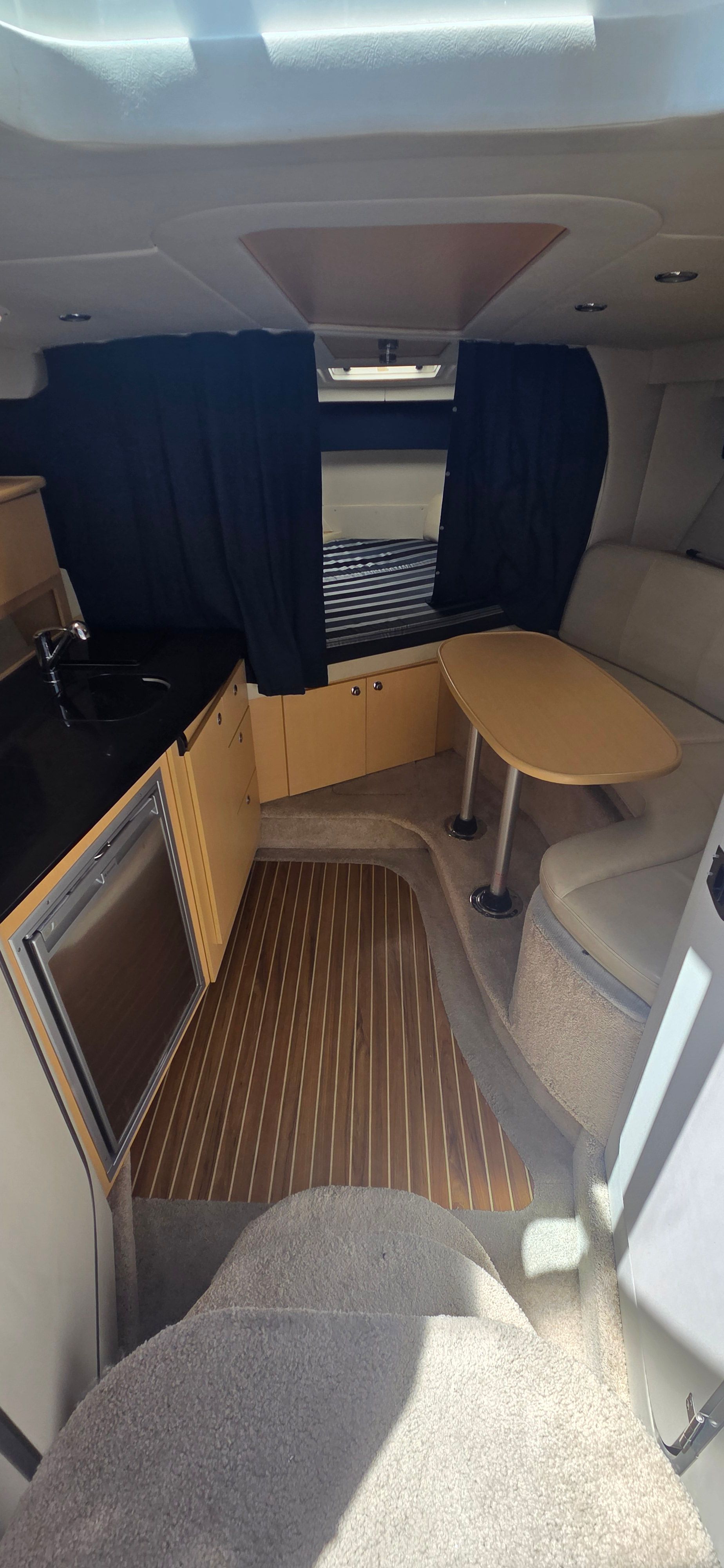 Interior of 2012 Bayliner 335 Cruiser with kitchenette and seating area.