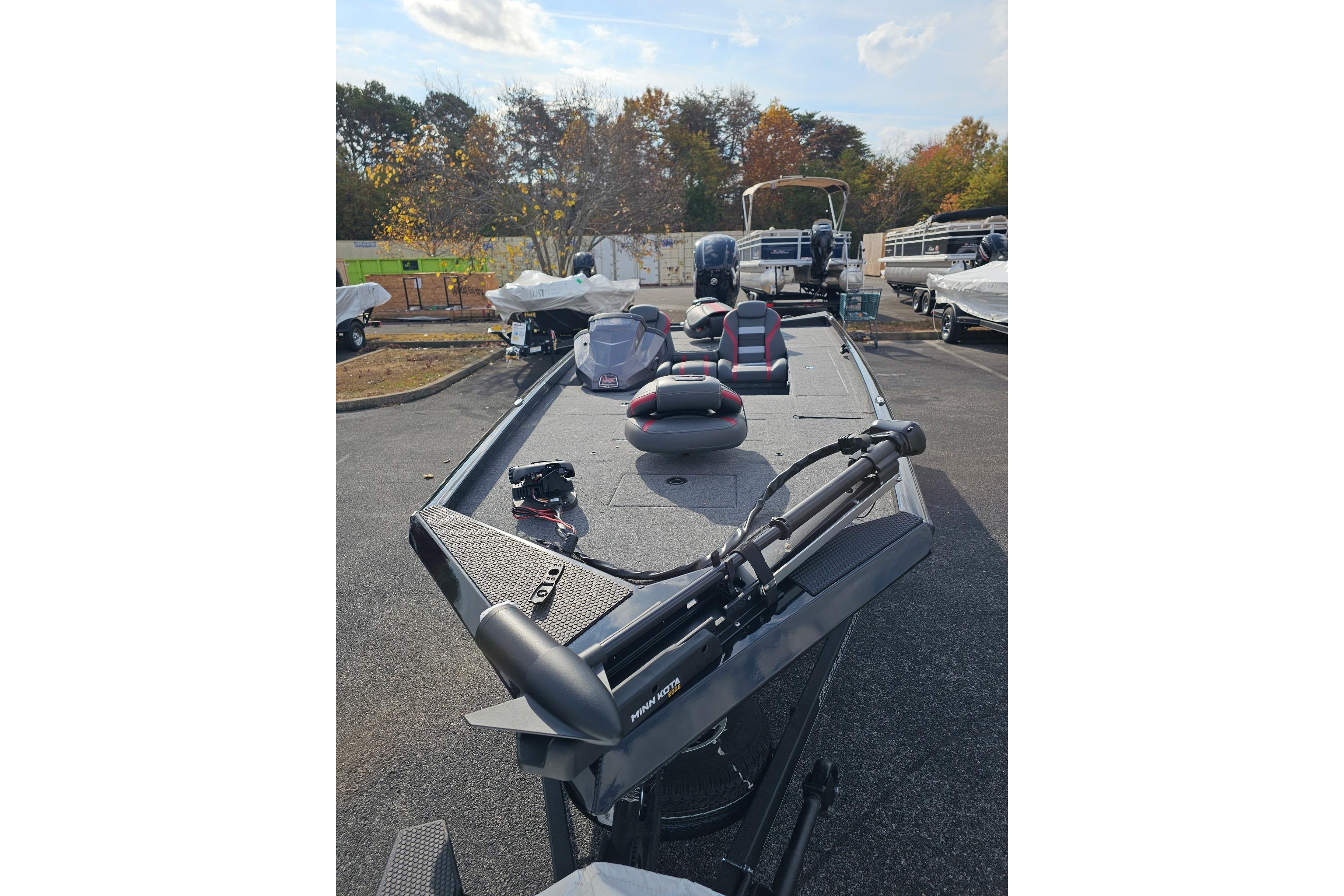 2026 Ranger RT188C fishing boat with trolling motor, parked outdoors.
