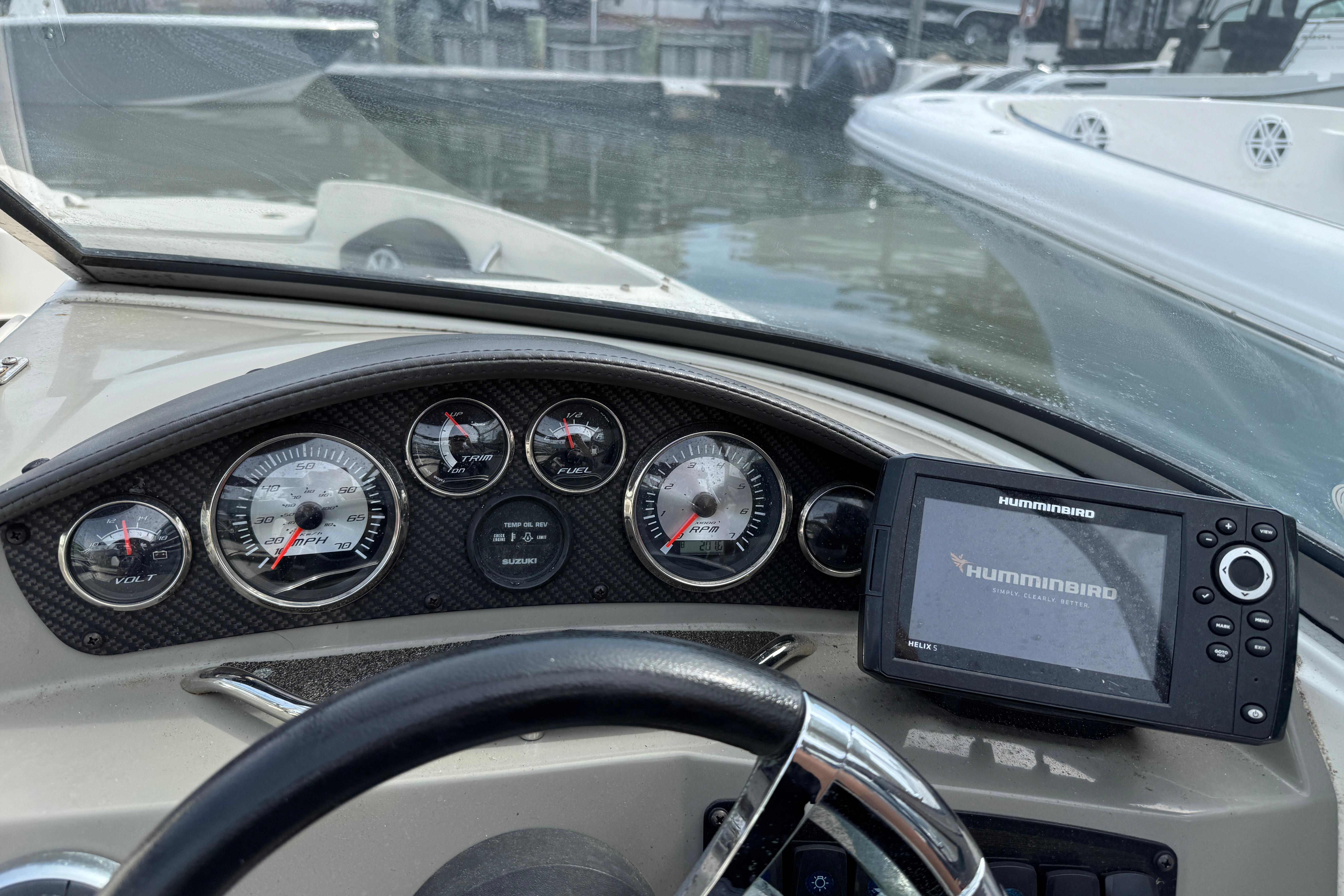 Dashboard of a 2018 Stingray 204 LR boat with gauges and Humminbird GPS.