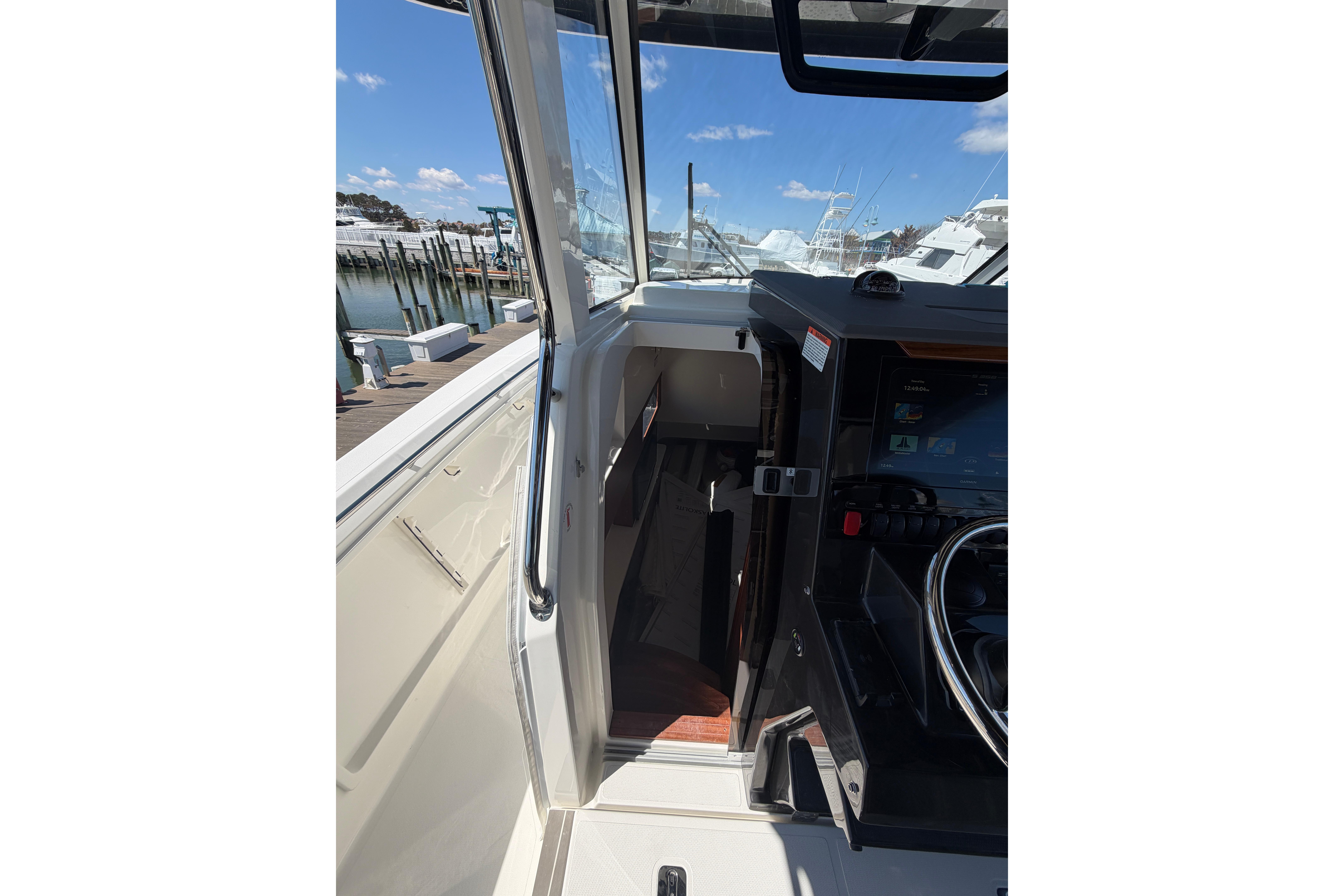 2026 Pursuit S 358 Sport boat interior with helm and cabin entrance.