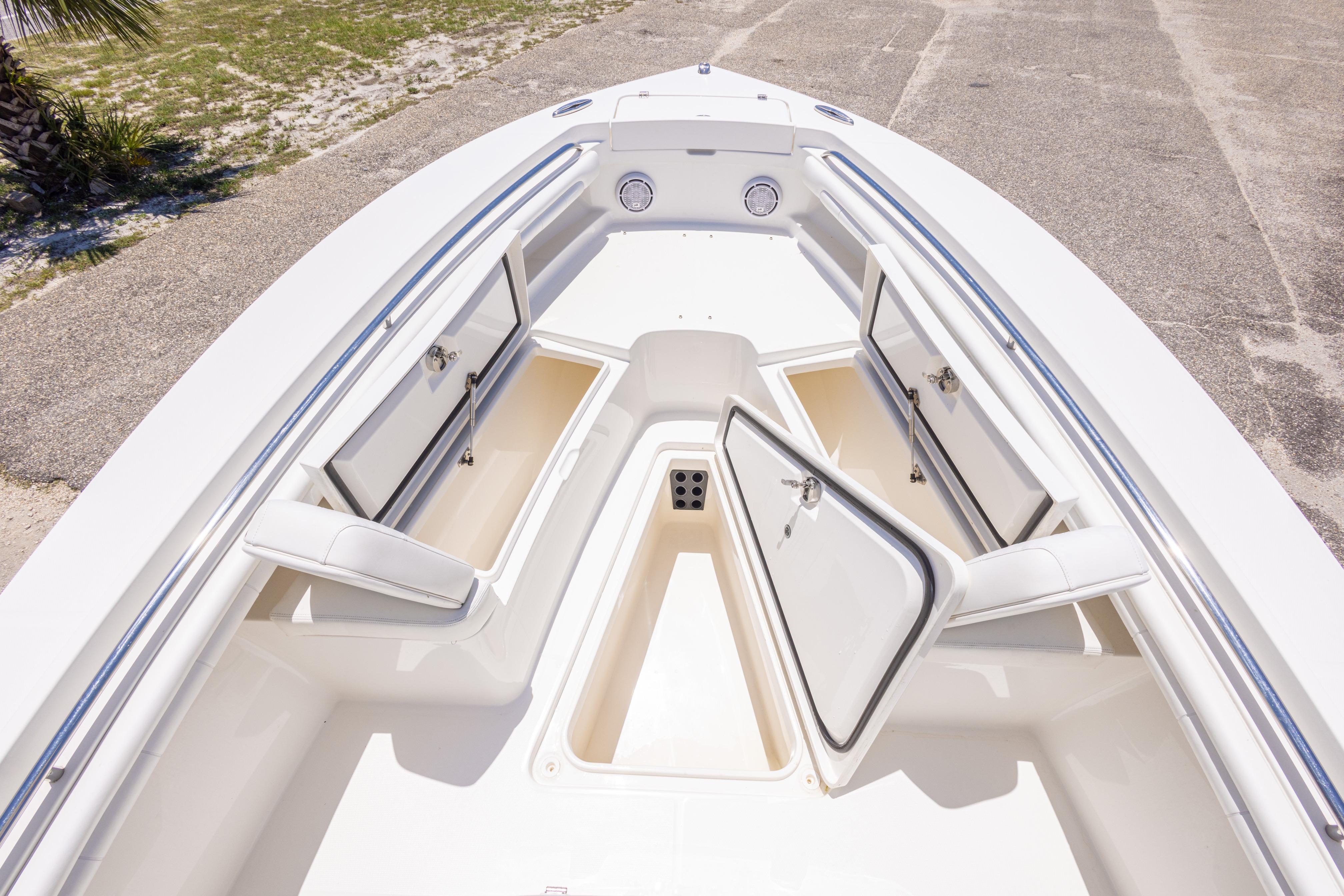 2019 Regulator 23 Center Console boat with open storage compartments on deck.