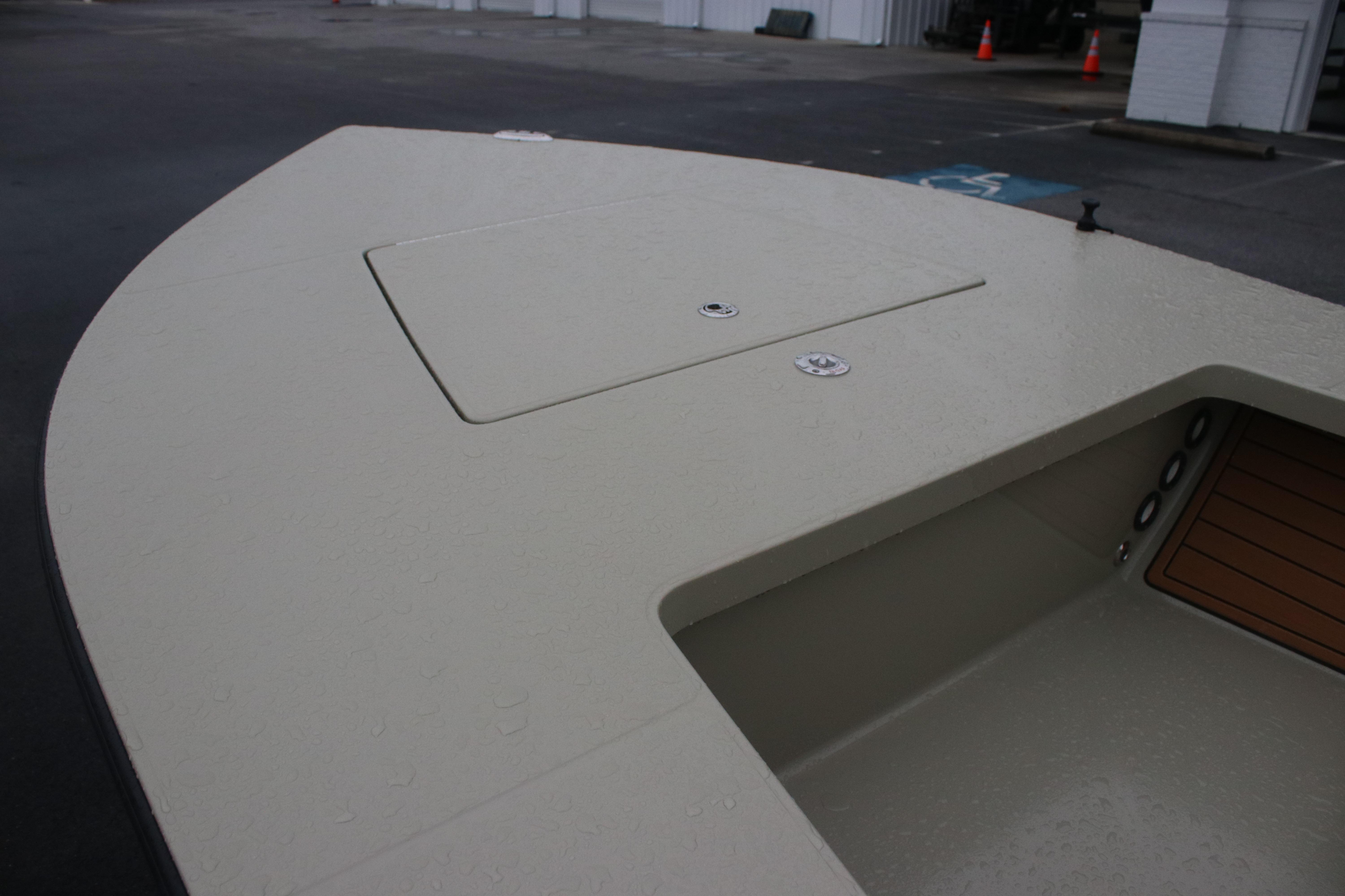 2026 East Cape EVO 18V boat deck with storage compartment, showcasing sleek design.