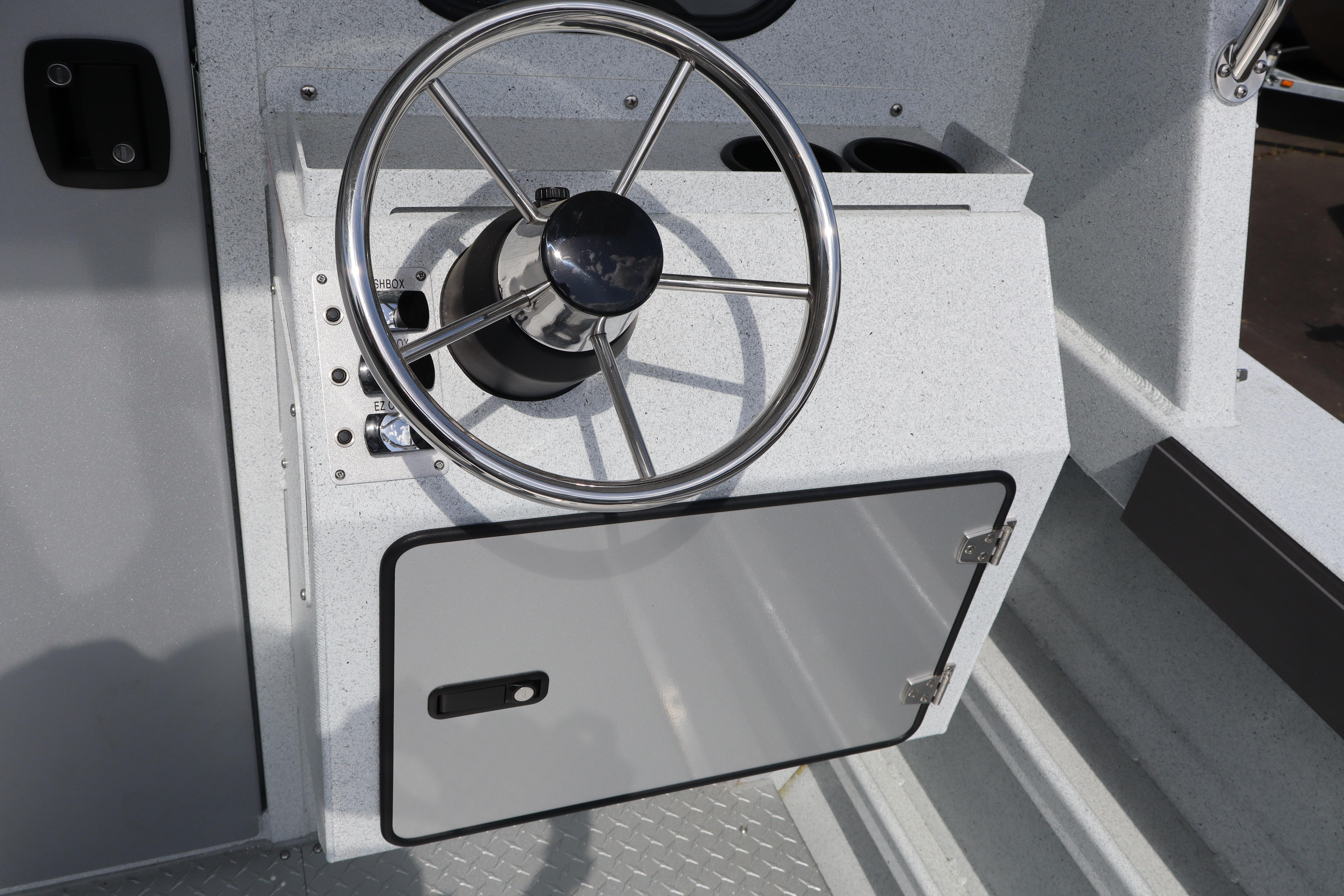 Steering wheel of 2026 KingFisher 2425 Escape HT boat, featuring sleek design and controls.