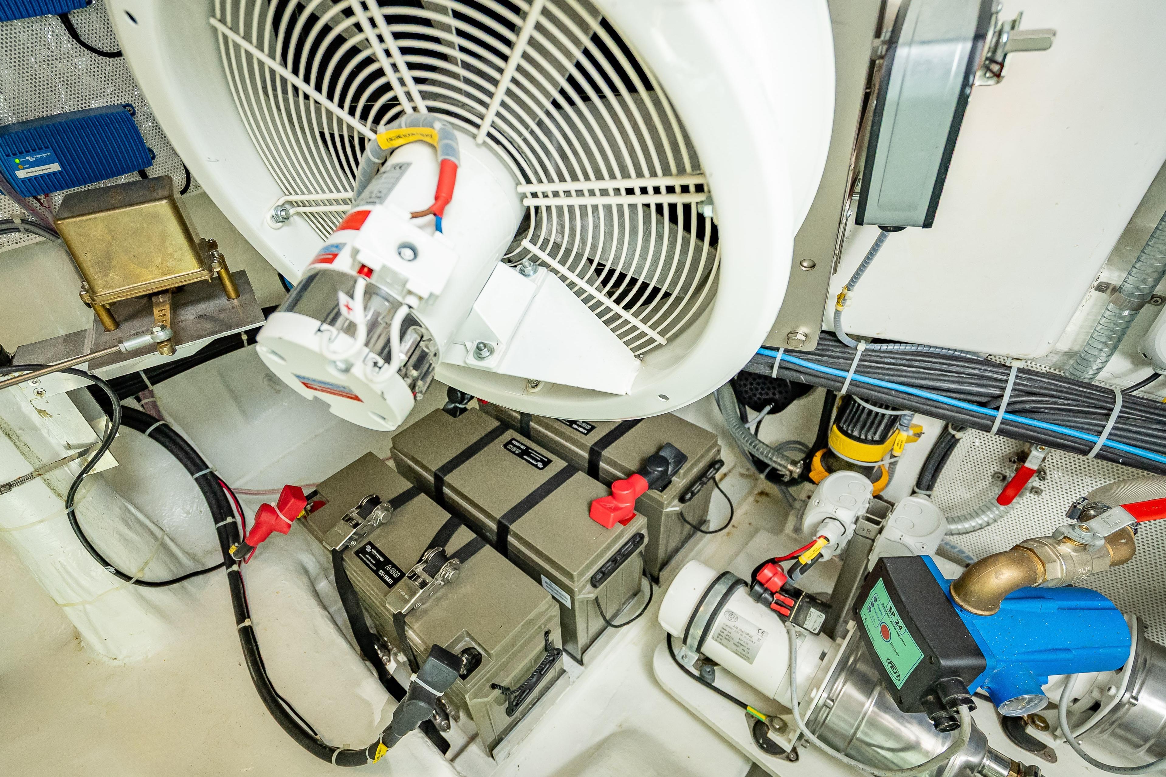 Engine room of 2026 Sunreef 60 Power yacht, showcasing mechanical components and wiring.