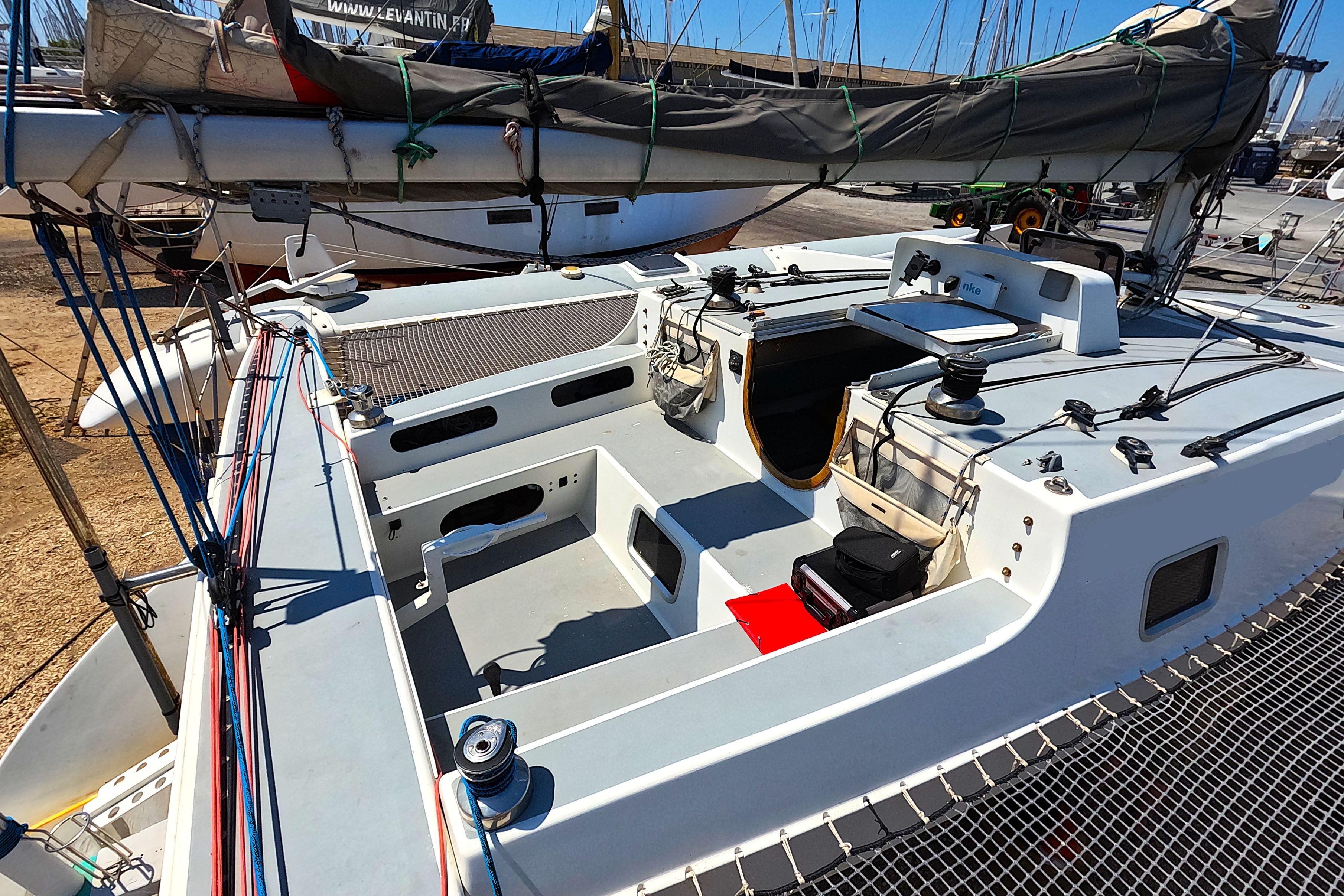 Custom TRIMARAN PULSAR 33 sailboat, 2002 model, docked with visible deck and rigging.