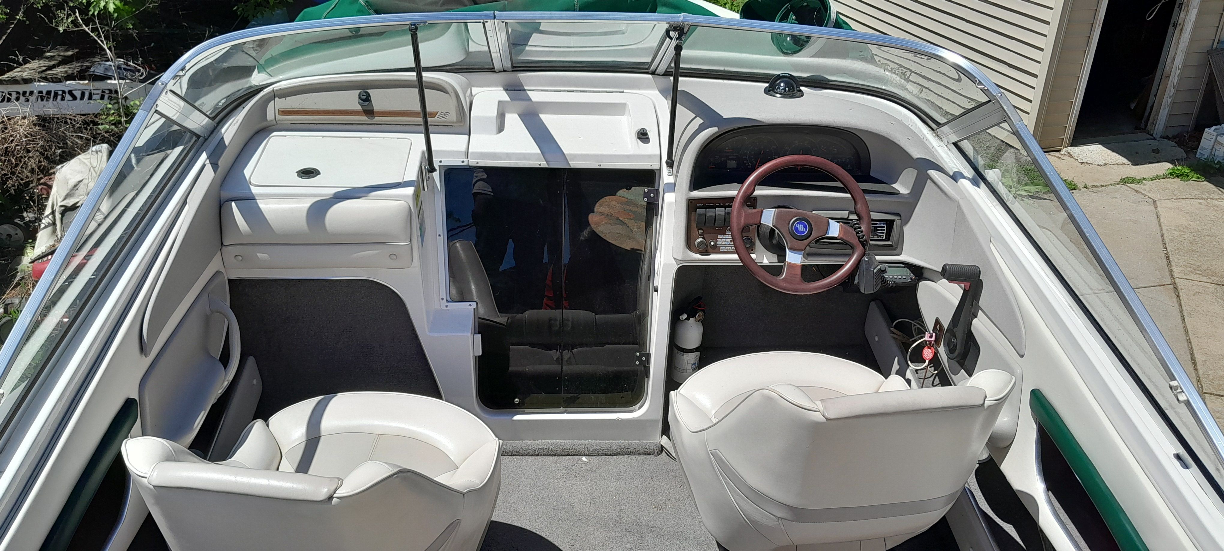 Interior of a 1995 Four Winns 205 Sundowner boat with white seating.