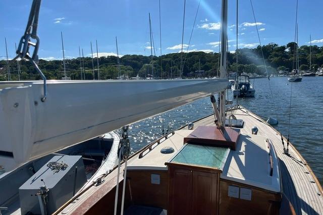 Sailboat deck view on water, Morris 36, 2006 model, sunny day, marina background.