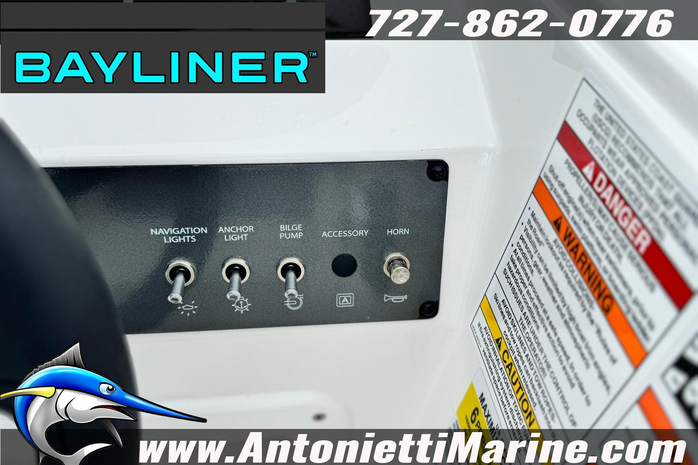 Control panel of 2026 Bayliner Element E16 boat with switches and safety warnings.