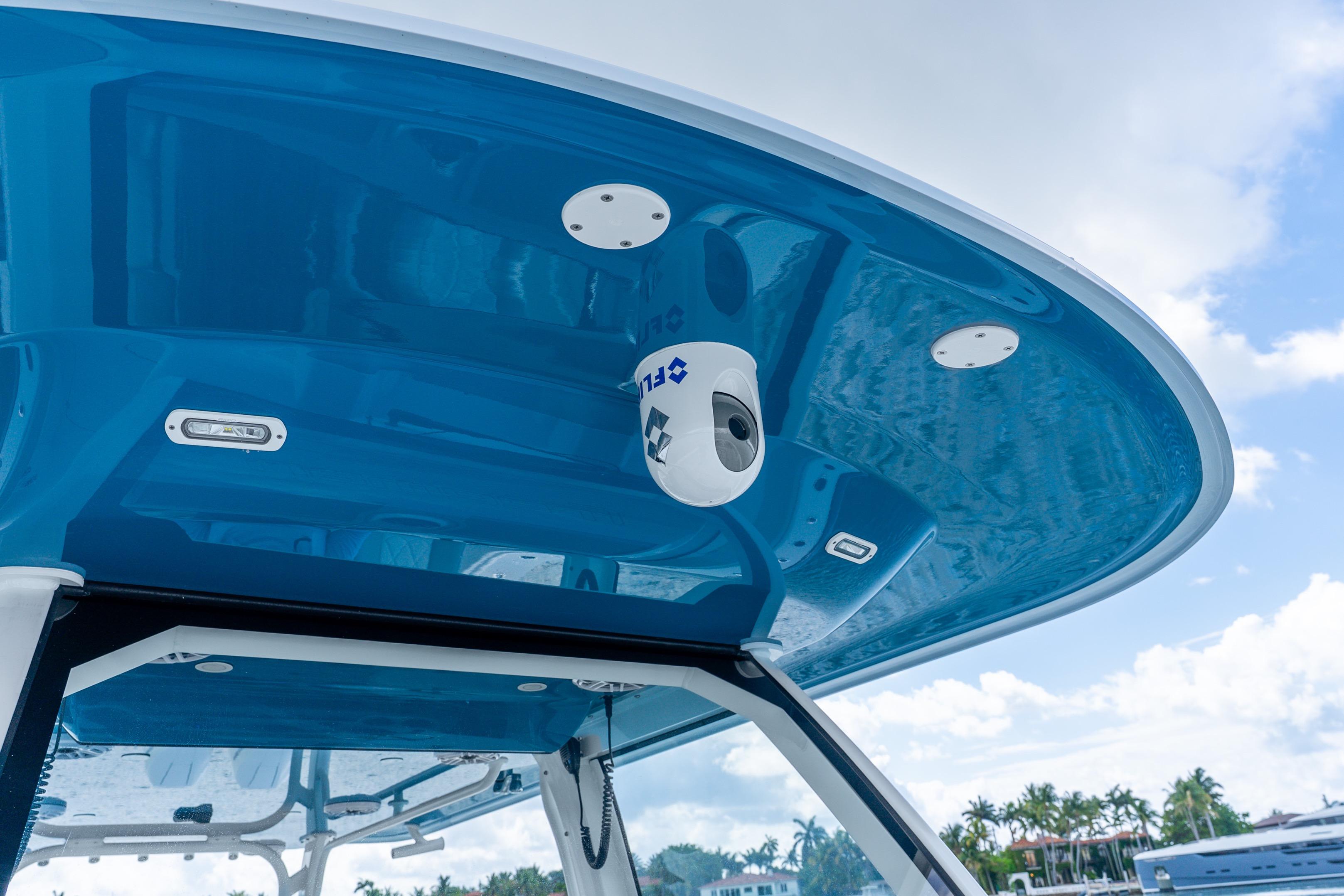 2024 Freeman 47 boat with blue canopy and mounted camera system.