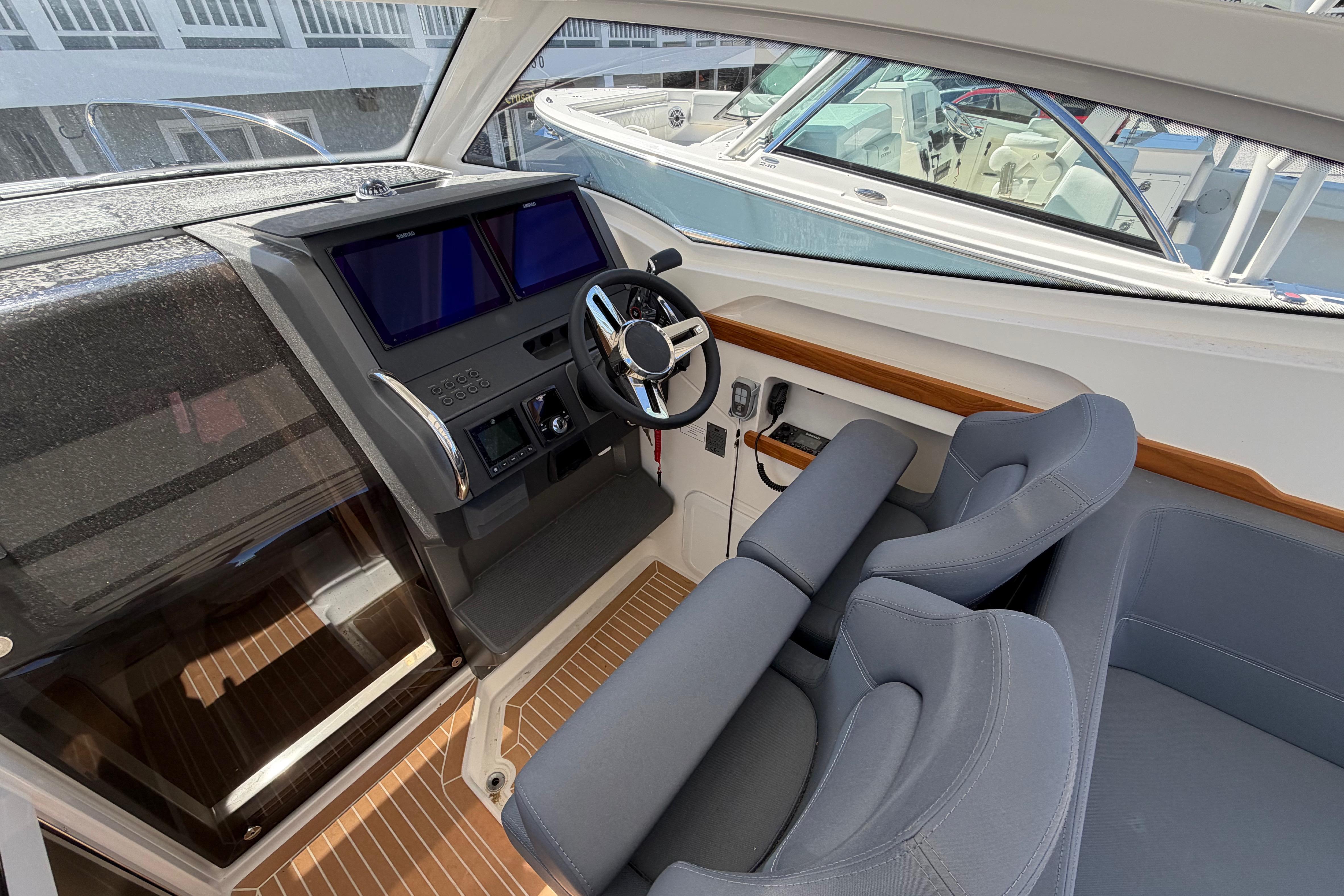Interior cockpit of 2025 Nimbus Weekender 9 boat with modern controls and seating.