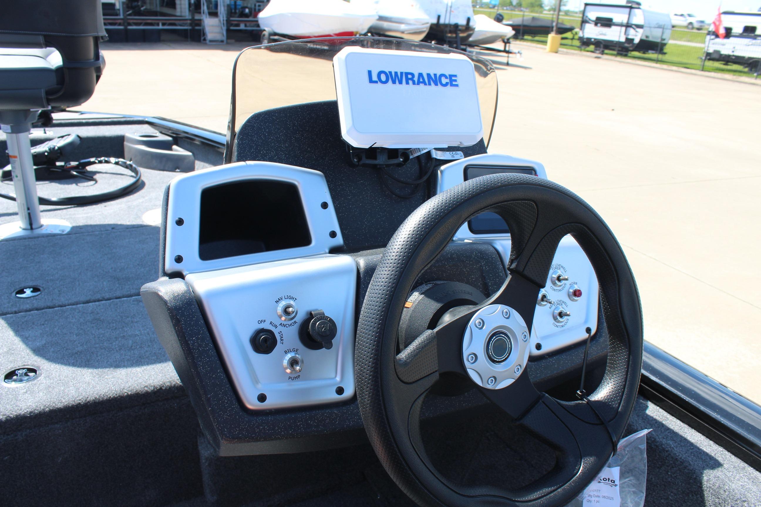 2026 Tracker Pro Team 175 Crappie Edition boat dashboard with steering wheel and Lowrance display.