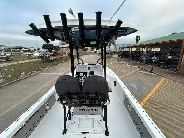 2024 Sea Pro 250 DLX boat interior with seating and rod holders.