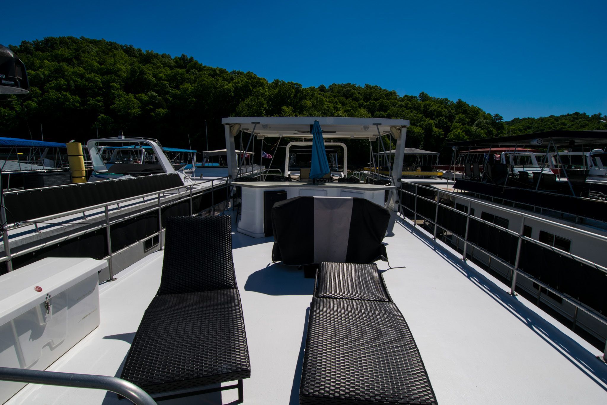 2003 Lakeview 16x70 houseboat with sun deck and lounge chairs.